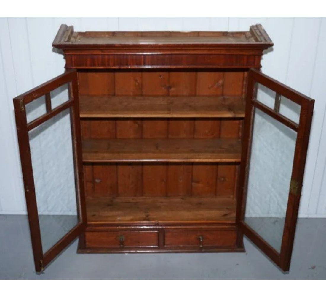 small antique bookcase with glass doors
