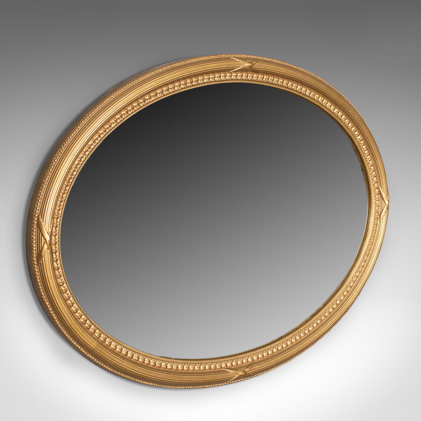 This is an antique wall mirror, an English, Early 20th century giltwood frame with later mirror plate, dating to circa 1920.

A super giltwood frame in good order
In the classical revival taste
Ovular form to hang landscape or