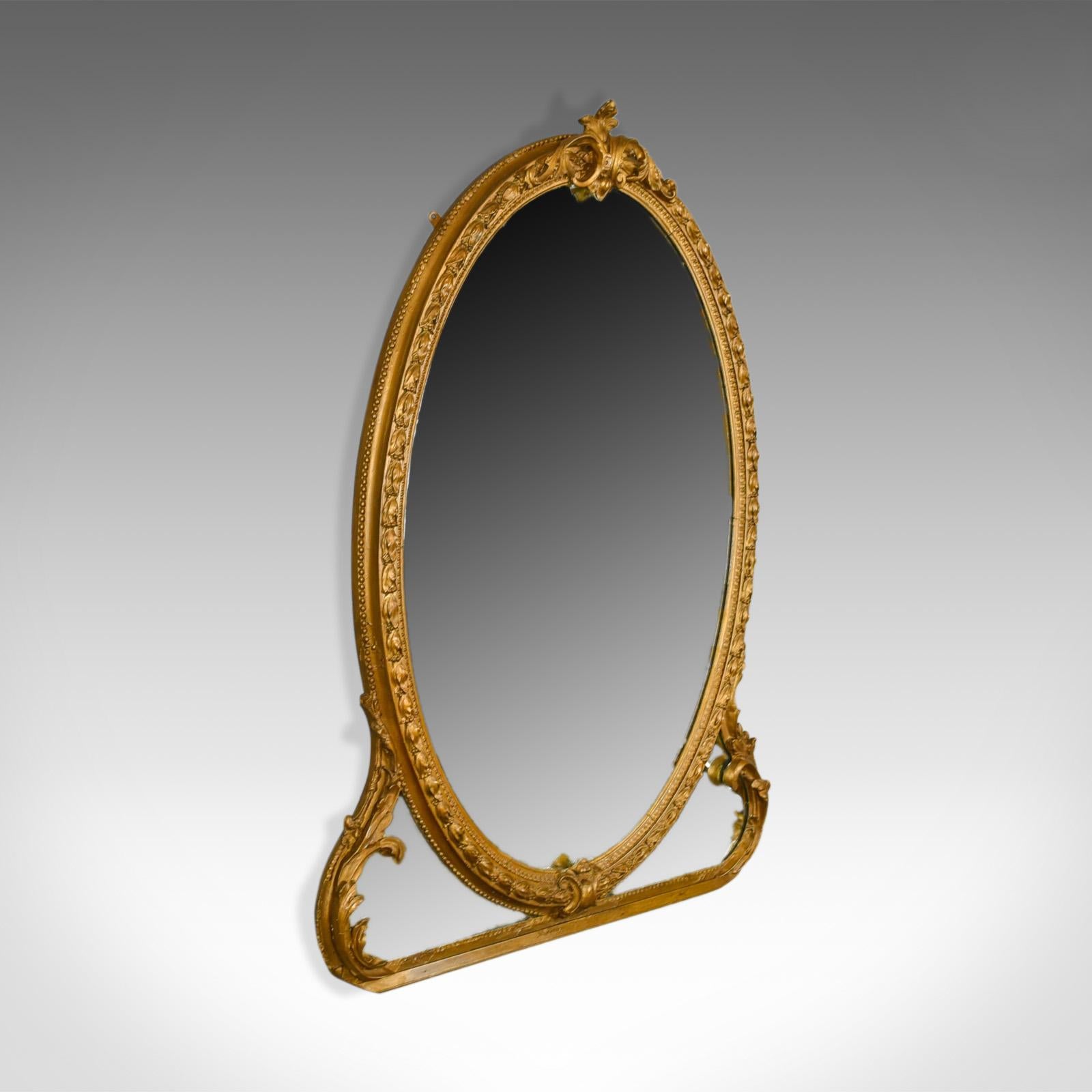 This is an antique wall mirror, an English Victorian, gilt gesso frame with later mirror plate, a 19th century overmantel mirror dating to circa 1850.

A super period gilt gesso frame
Victorian in the classical taste
Decorated with scrolls,