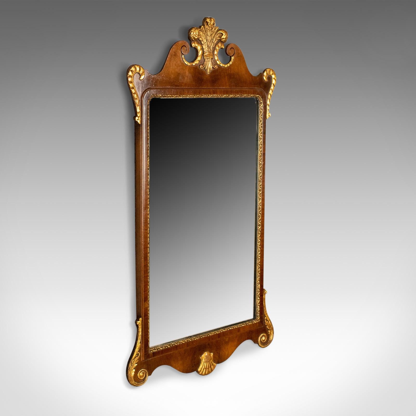 This is an antique wall mirror, an English, Victorian vanity mirror in walnut with gilded decoration dating to circa 1880.

A delightful, mid-sized wall mirror with regal overtones
Sumptuous dark walnut highlighted with gilded
