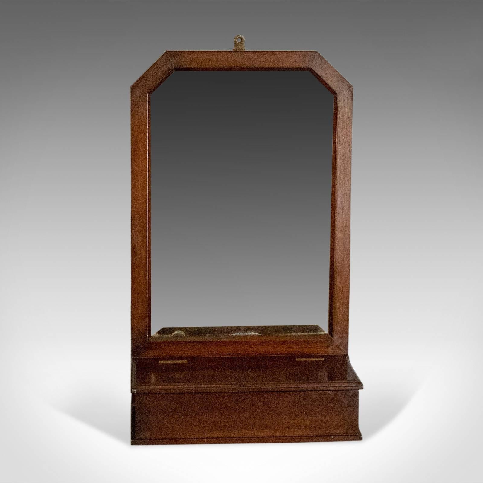 This is an antique wall mirror valet, an English hall glove box, a Victorian piece dating to circa 1890.

Victorian valet station complete with glove box
Ideal for wall mounting or free standing
Glove box offers useful storage beneath 
Good