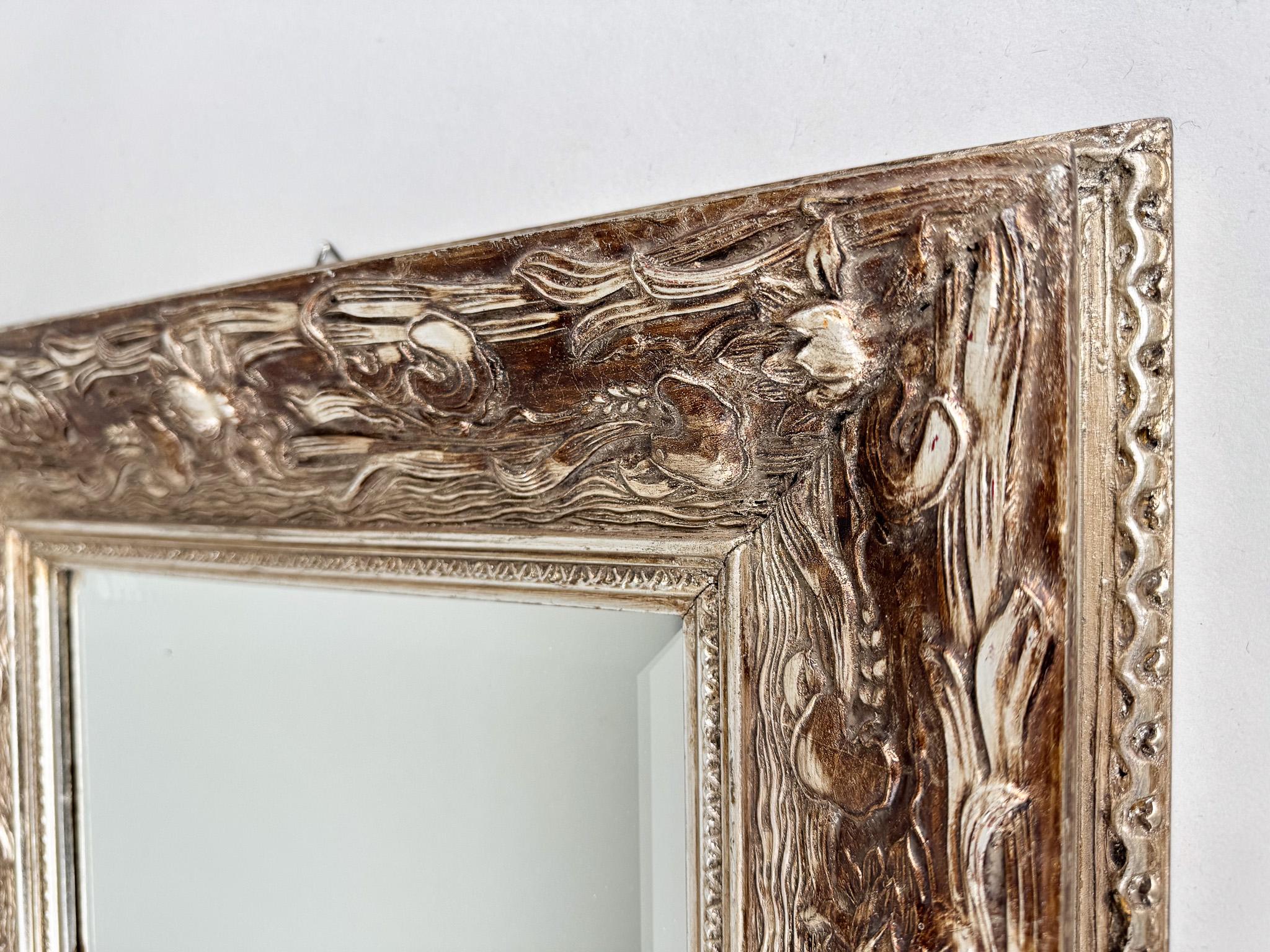 Miroir mural ancien à facettes dans un beau cadre décoratif en bois. Originaire de France.