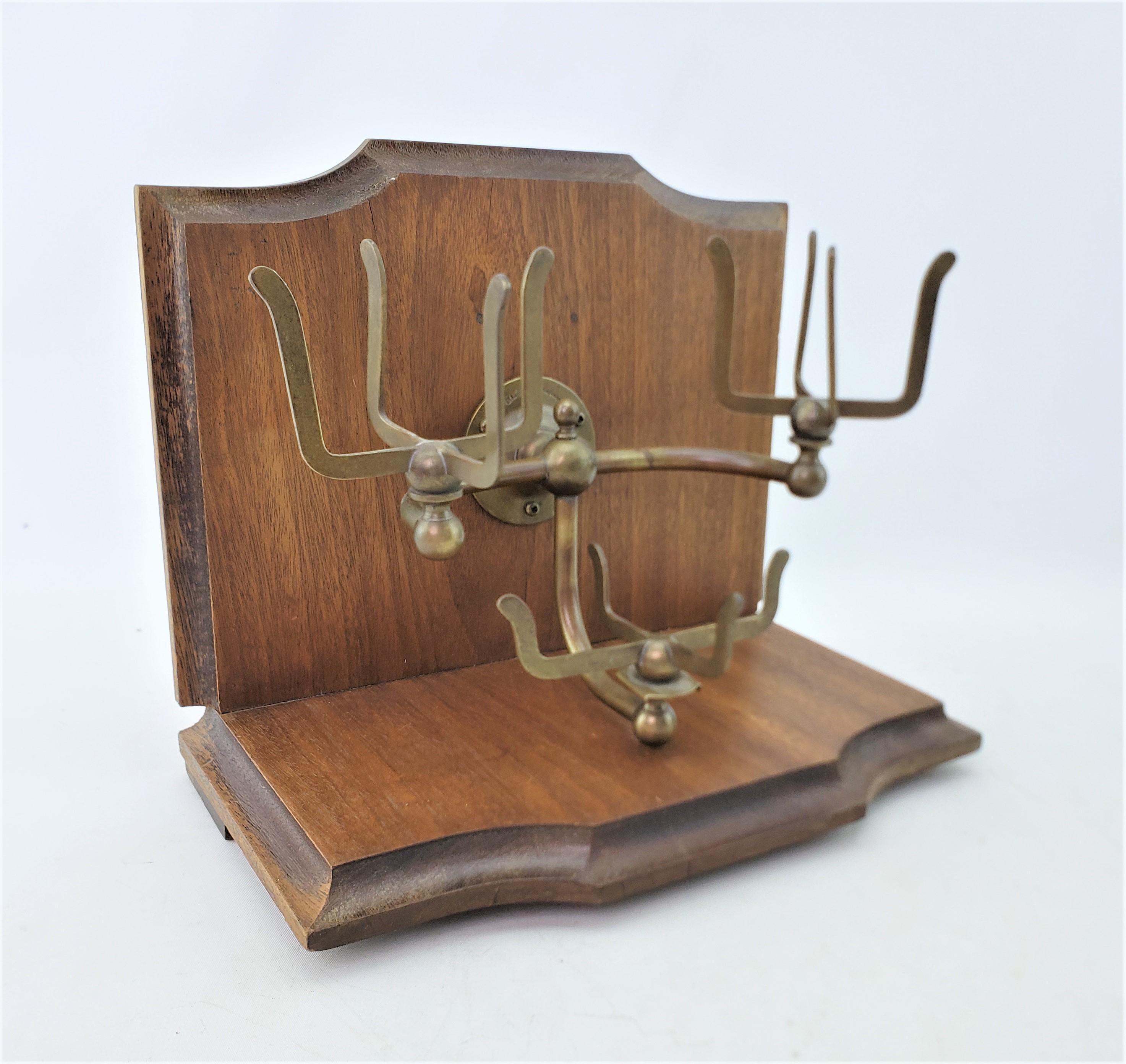 This antique bathroom fixture was made by the Brasscrafters of the United States and dates to approximately 1920 and done in the period Art Deco style. The fixture is composed of brass and has a sturdy wall mounting bracket with two prong cup