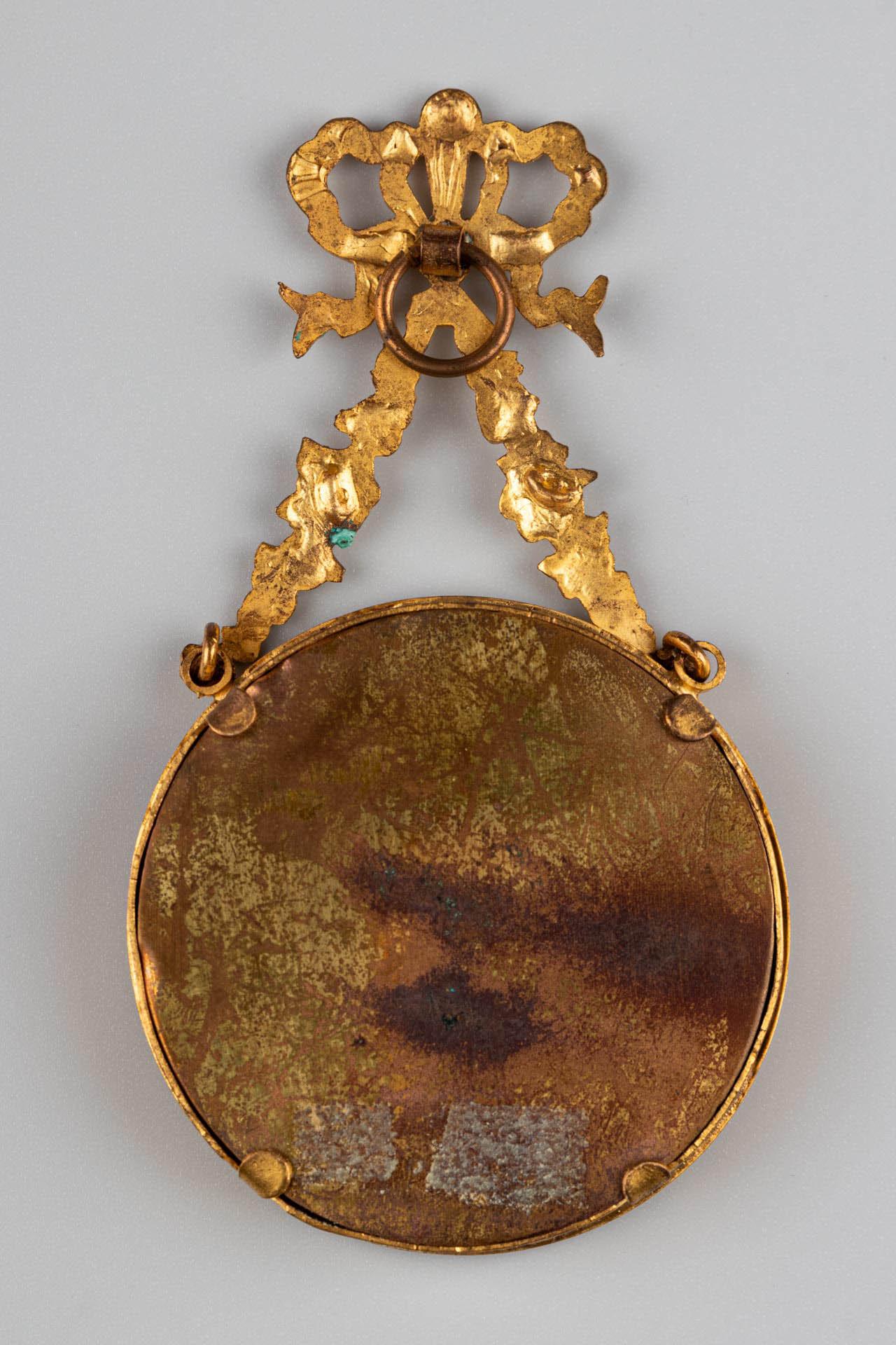 Beautiful brass picture frame for wall installation, France, circa 1880.
Picture size: 5 cm x 5 cm.
Hanging ring on the top for wall installation, hidden behind a wonderful bow and flowery ornaments.

