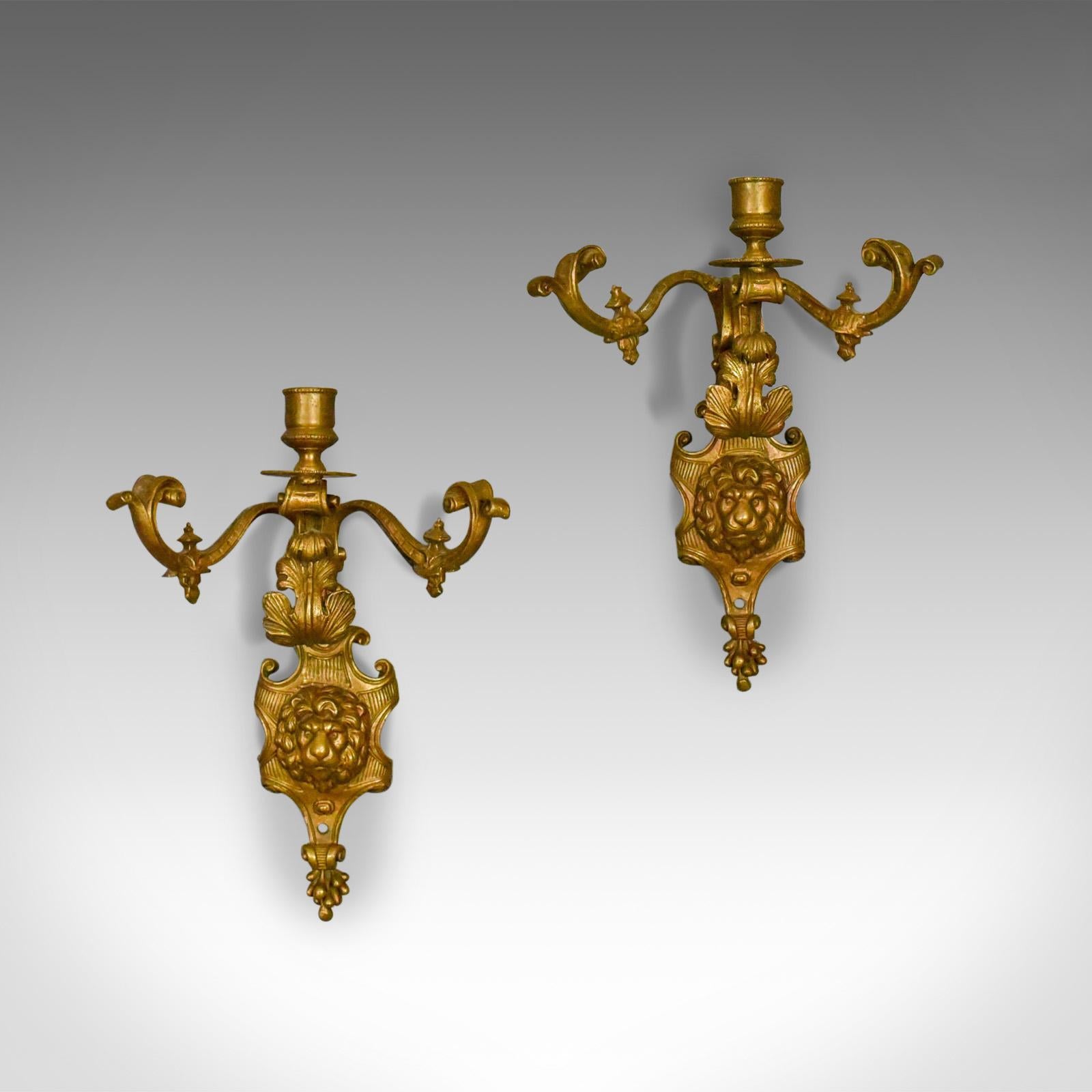 This is a pair of antique wall sconces, English, Victorian, gilt metal candle stands dating to circa 1900.

Delightful pair of gilt metal wall sconces
Central candle stand over scrolled foliate detail
Flanked by a pair of serpentine decorative