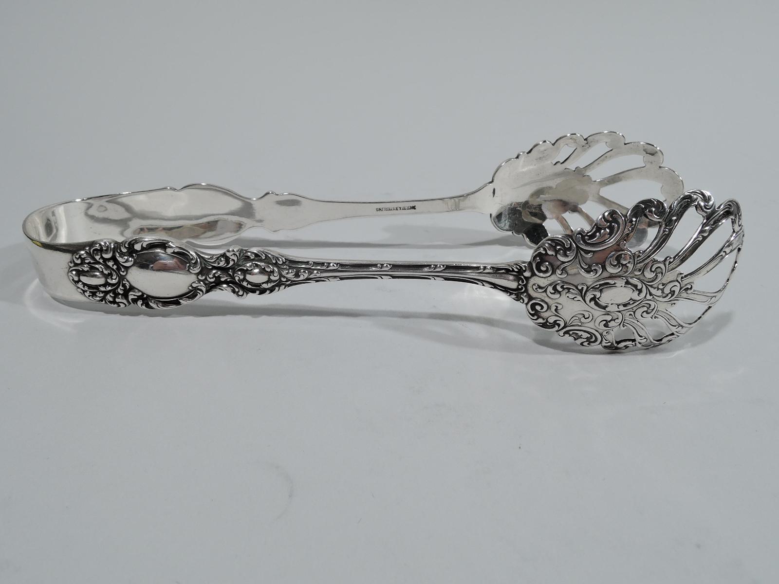 Lucerne sterling silver ice tongs. Made by R. Wallace & Sons in Wallingford, ca 1910. U-form with open and scrolled jaws. Terminals have dense scrollwork with large oval frame between two small ones. All frames vacant. A pretty piece in this late