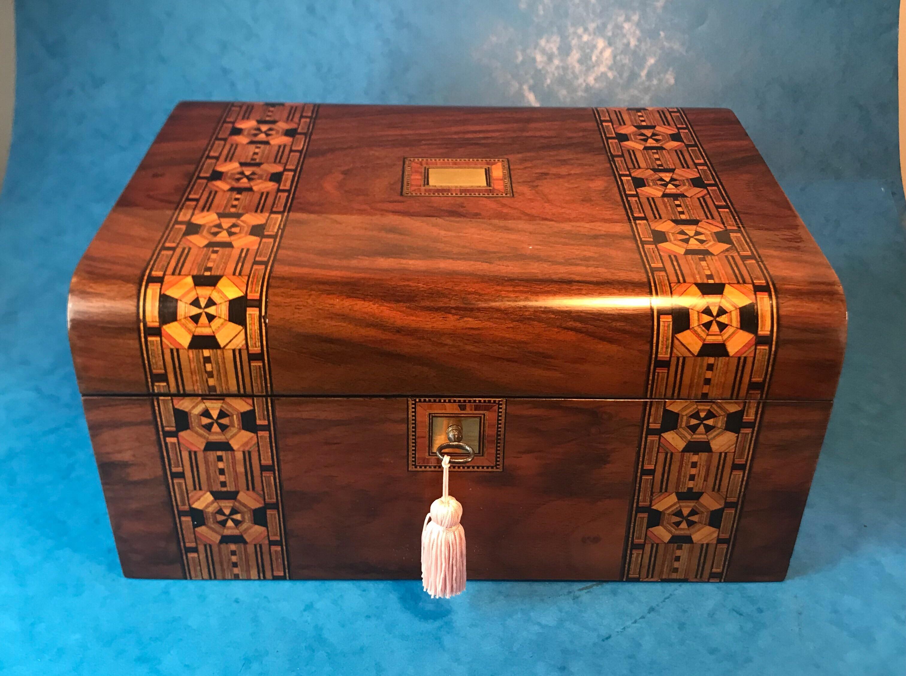 Antique walnut 1880 jewelry box. The jewelry box is banded with inlaid Tunbridge ware, it has a brass top and key escutcheon and a fully working lock and key. The jewellery box interior has its original tray that’s been partly relined with