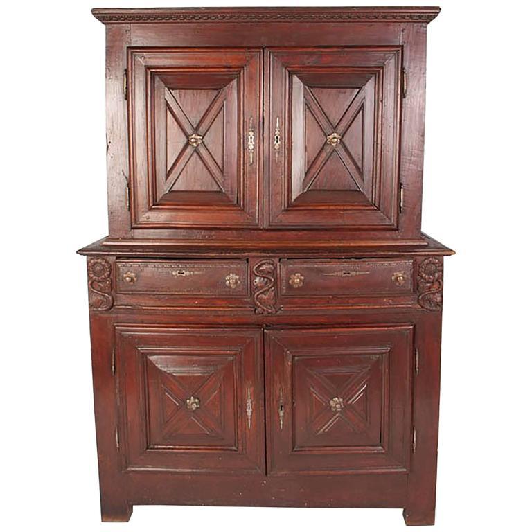 Antique French bahut deux corps armoire. Double chested walnut armoire with carved floral and X-motifs, with two drawers.