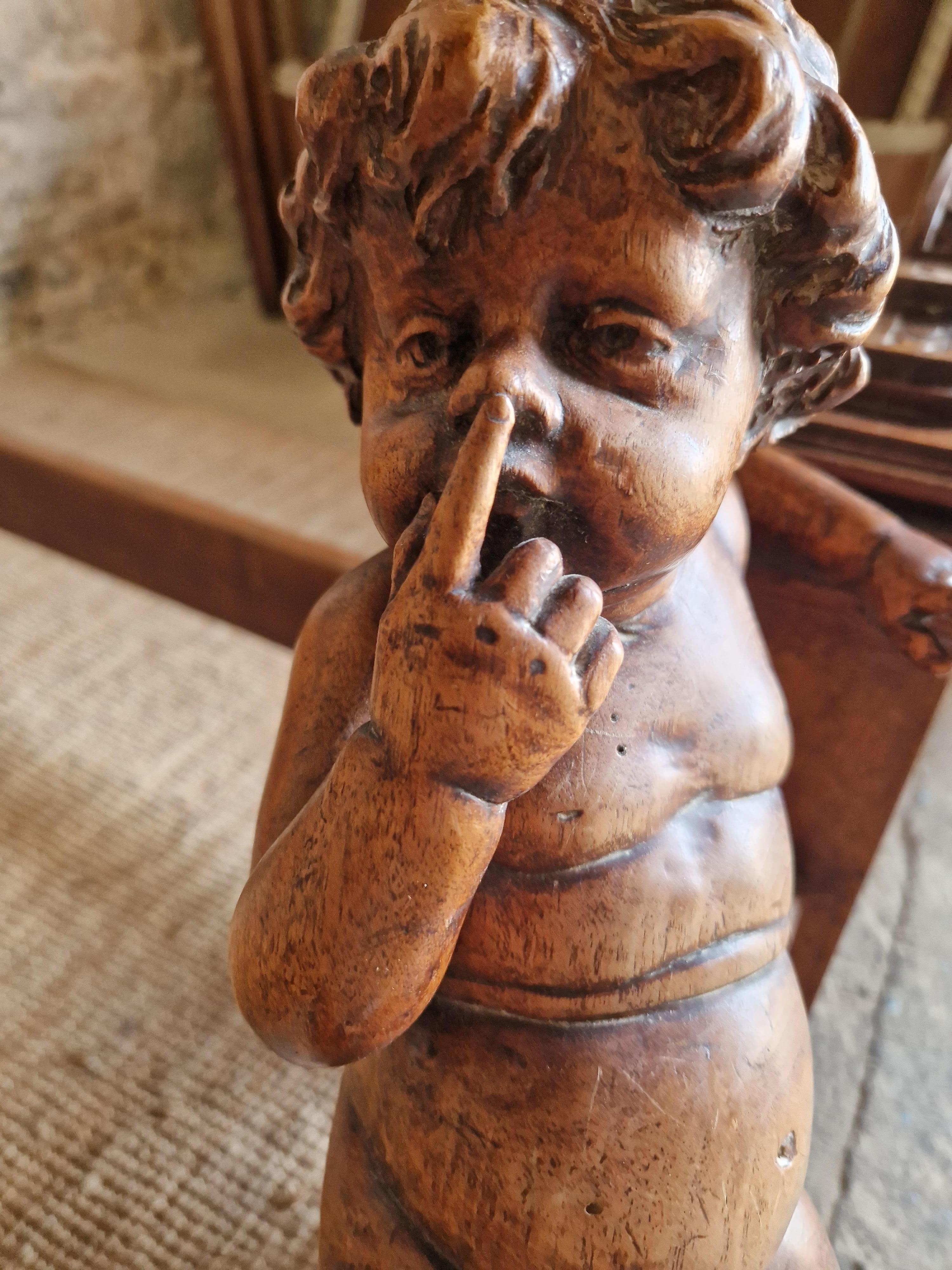 This Antique Italian Renaissance Revival Bed is a stunning example with the most perfect little Putti Cherub sitting on the end of the bed, with intricate carvings in a warm walnut finish. Crafted in Italy in Circa 1850, this bed has a rectangular