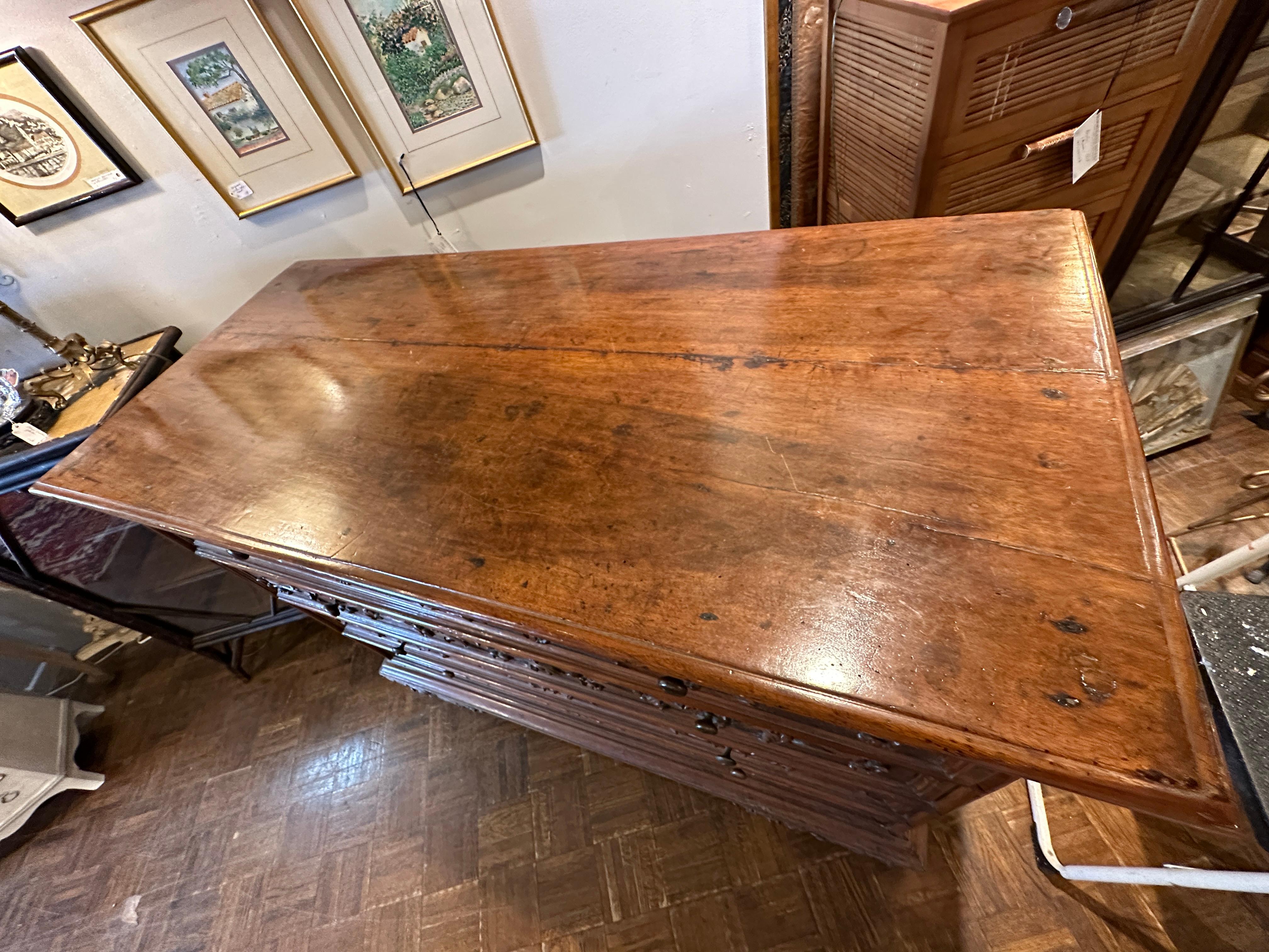 19th Century Belgium large chest of drawers in walnut wood. 
Four large drawers with beautifully carved panels and carved feet.  Wonderfully aged with beautiful patina.
All four drawers pulls in and out easily.  Great for dining room server with