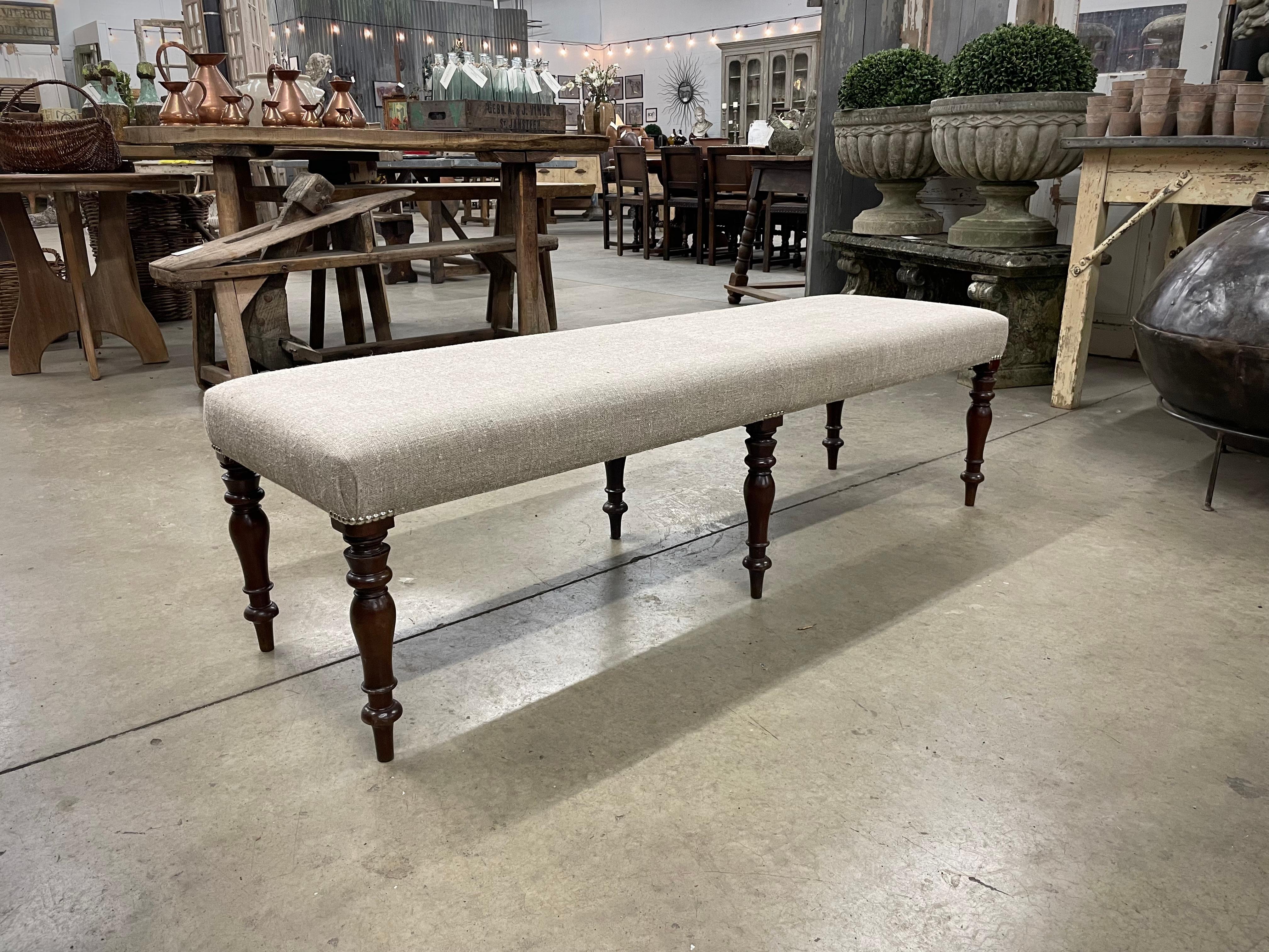 Beautiful walnut bench with turned legs. It has recently been upholstered in Belgian linen.

Perfect for the end of the bed, as extra seating or for a coffee table, with a tray of ourse!