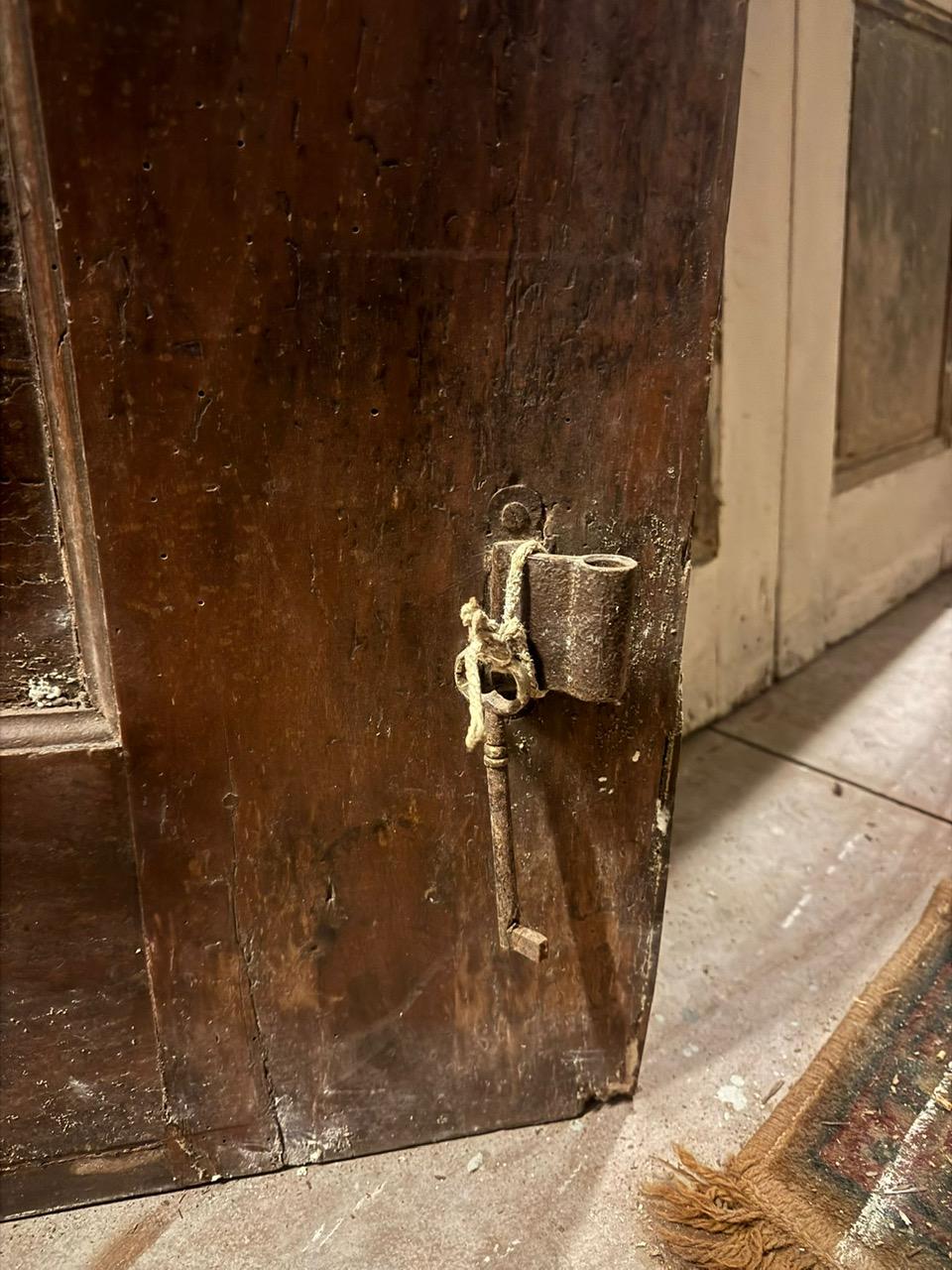 Walnut entrance door with three doors, carved panels and central knocker, italy 10