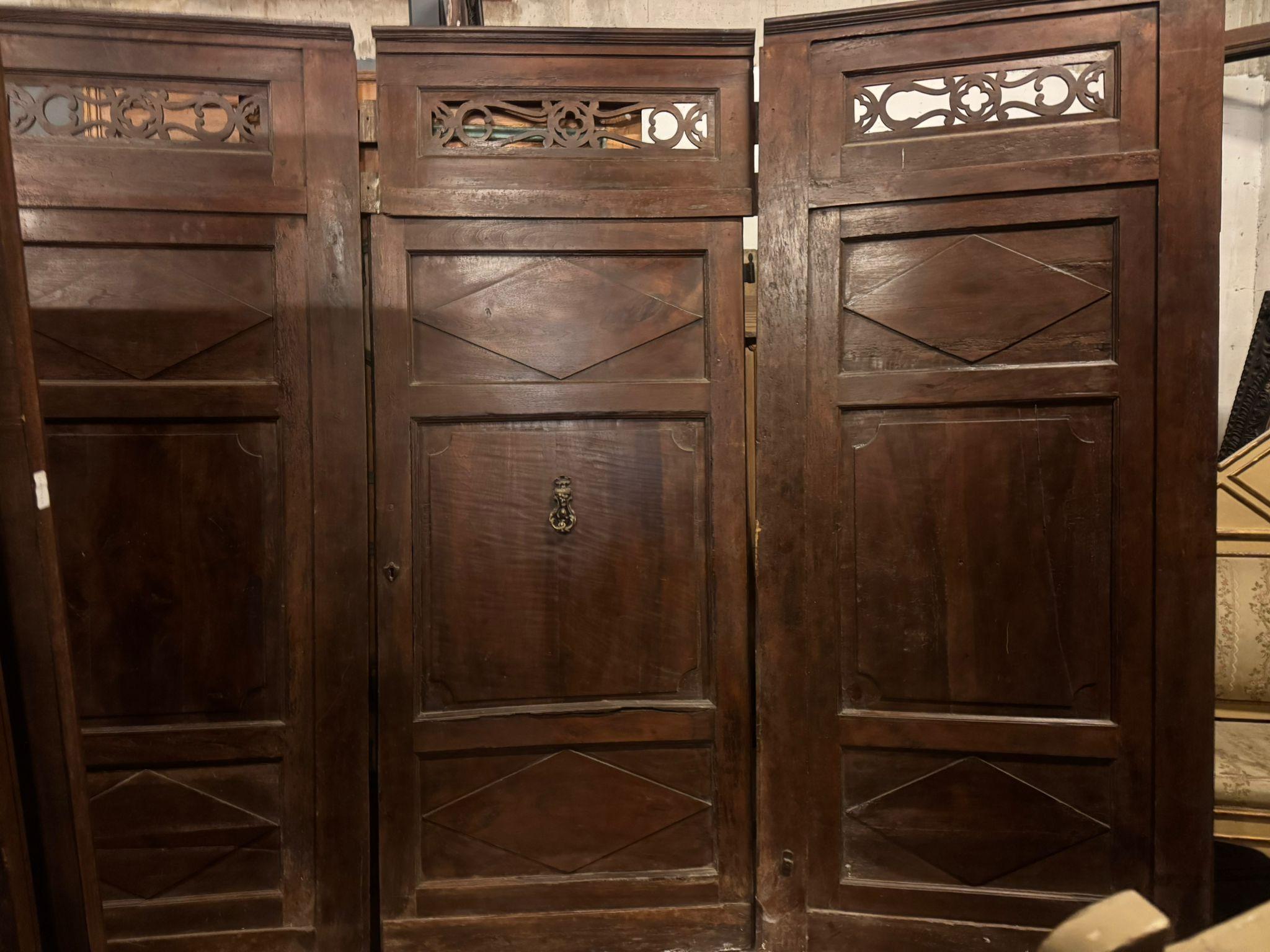 Hand-Crafted Walnut entrance door with three doors, carved panels and central knocker, italy