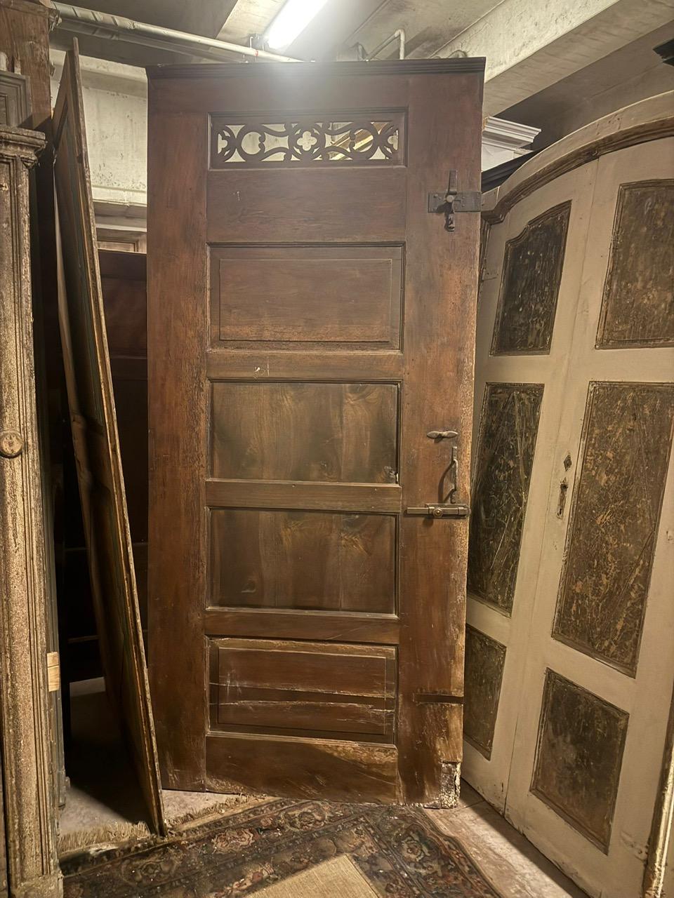 Walnut entrance door with three doors, carved panels and central knocker, italy 1