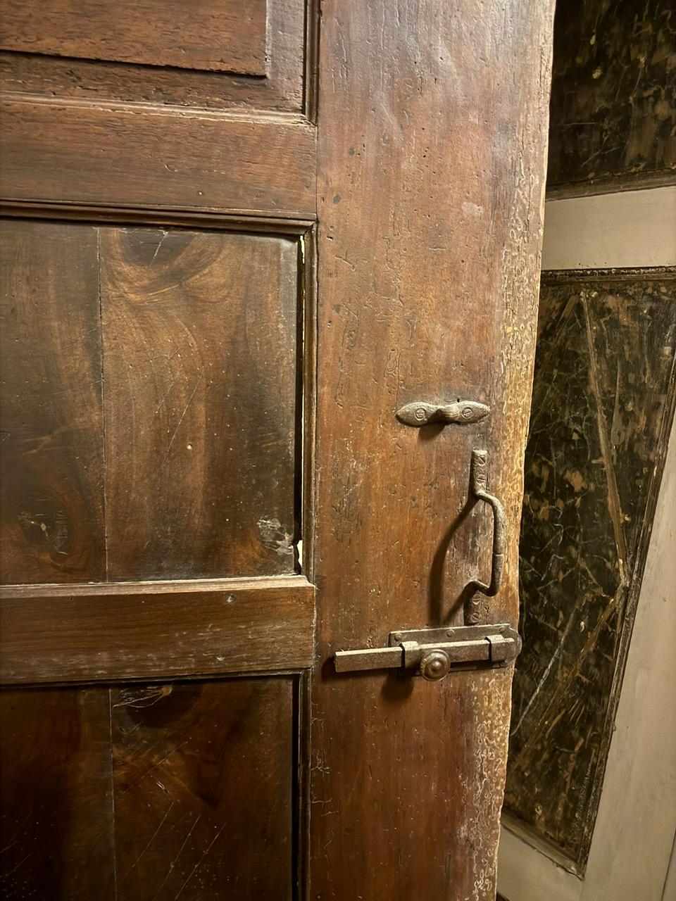 Walnut entrance door with three doors, carved panels and central knocker, italy 2