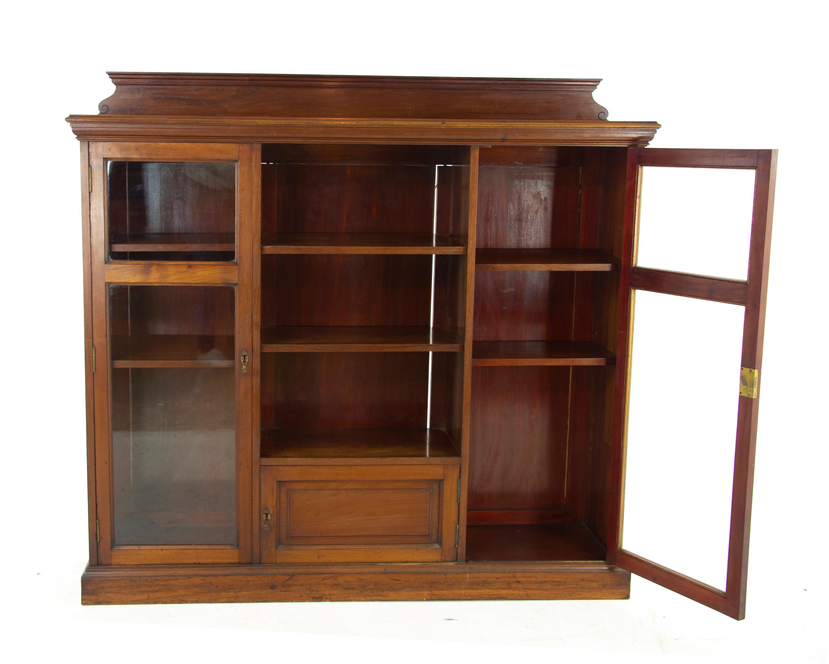 Antique walnut bookcase, walnut display cabinet, Victorian bookcase, Scotland 1890, Antique Furniture, B1164A

Scotland 1890
Solid walnut with original finish
Pediment above
Molded rectangular top
Open cupboard below with two adjustable