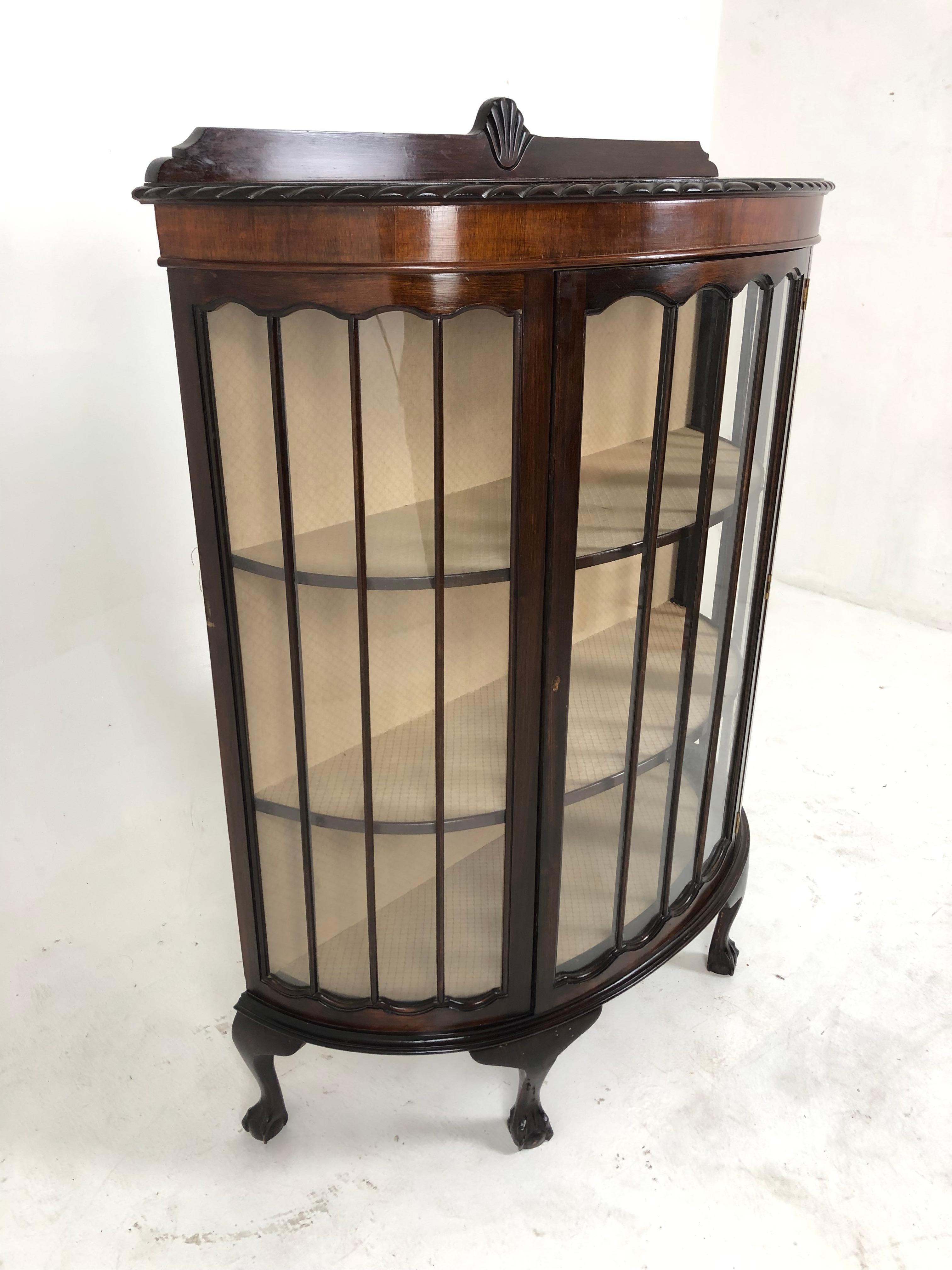 Antique walnut bow front china cabinet, display cabinet, Scotland 1920, H862

Scotland 1920
Solid Walnut and Veneer 
Original finish
Carved Pediment on top
Bow front with pie crust edge
Single glass door with 2 fixed shelves
Interior back and