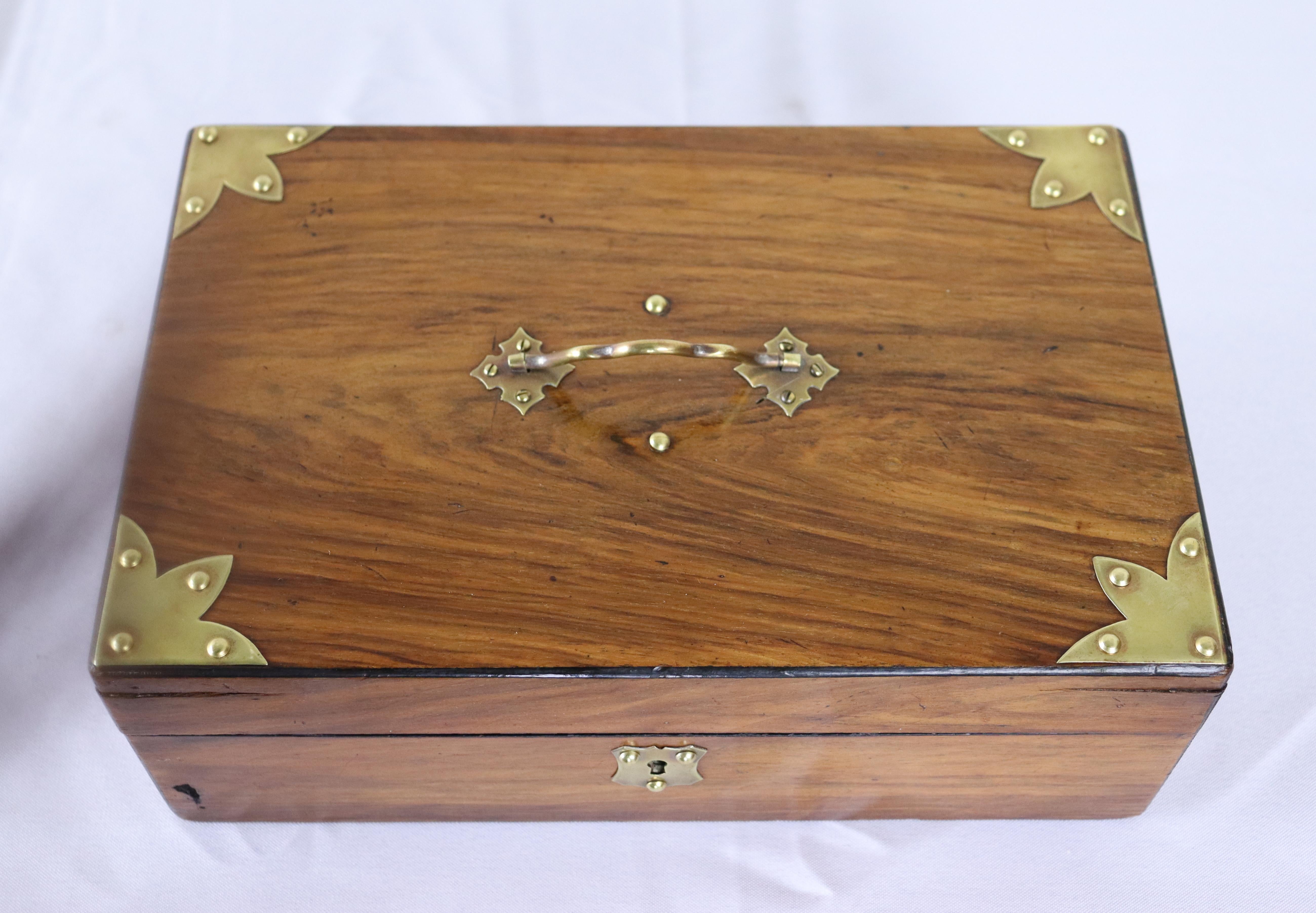 A charming walnut box with good color and patina.  The brass accents are eyecatching and in good condition.