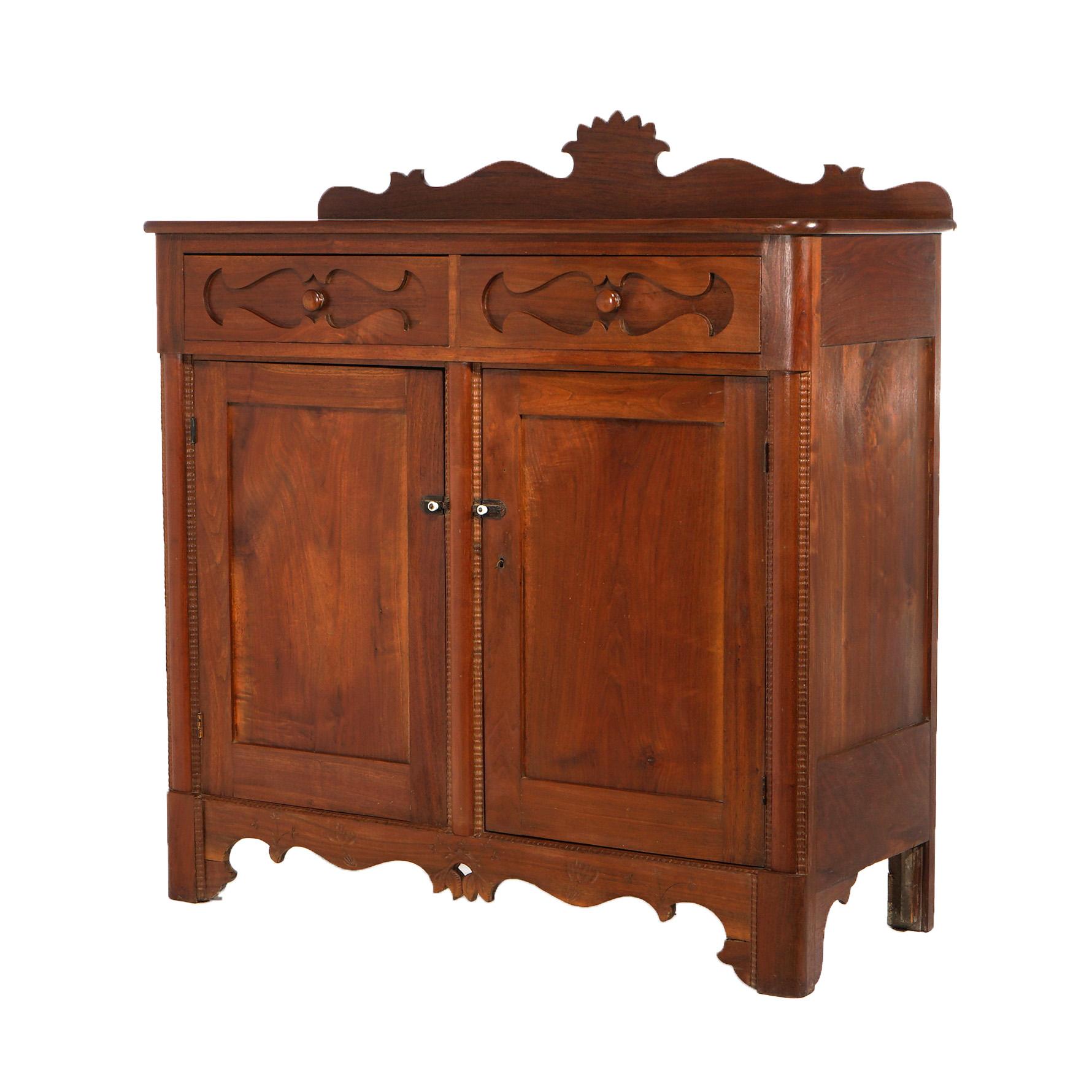 ***Ask About Reduced In-House Shipping Rates - Reliable Service & Fully Insured***
An antique country store sideboard or jelly cupboard offers walnut construction with shaped backsplash over double drawers with shaped panels over double door cabinet