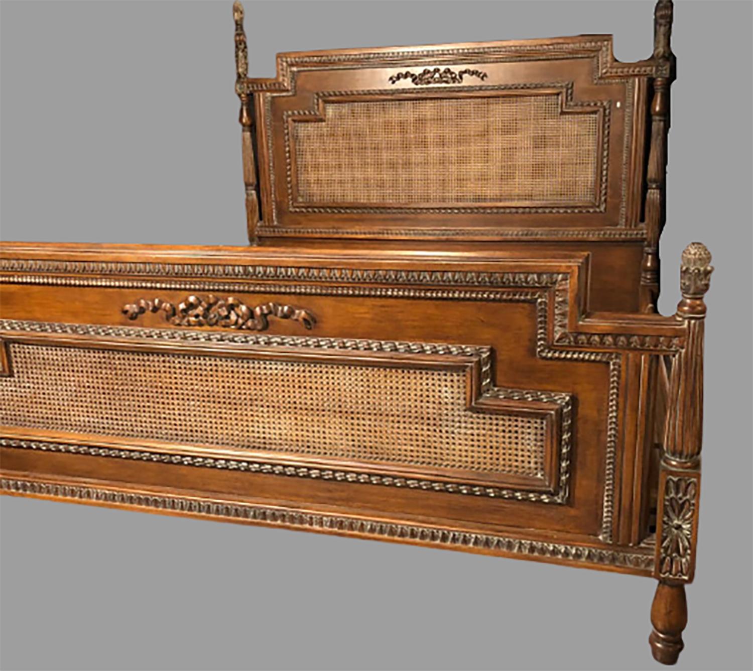 Antique walnut carved king sized bed. Headboard, foot-board and side-rails. This vintage finely carved and cane headboard and foot-board are simply stunning. Each having a ribbon and tassel carved front with pineapple carved posts, the set with cane
