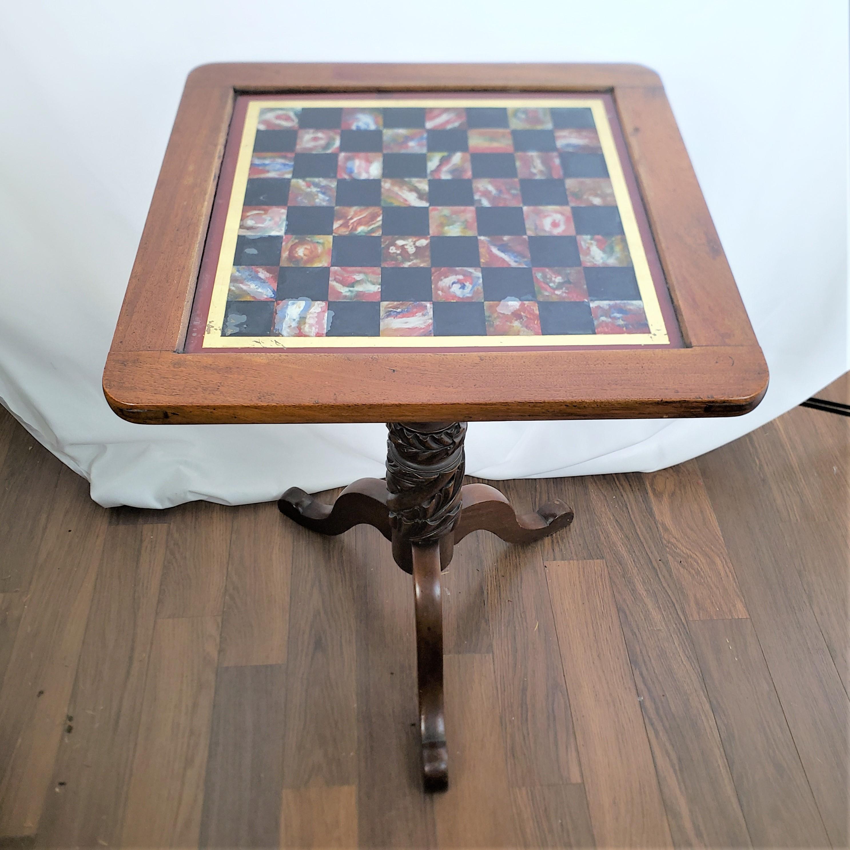This antique games table is unsigned, but presumed to have originated from the United States and date to approximately 1880 and done in the period Victorian style. The top of the table is made with a walnut surround with an inset reverse painted