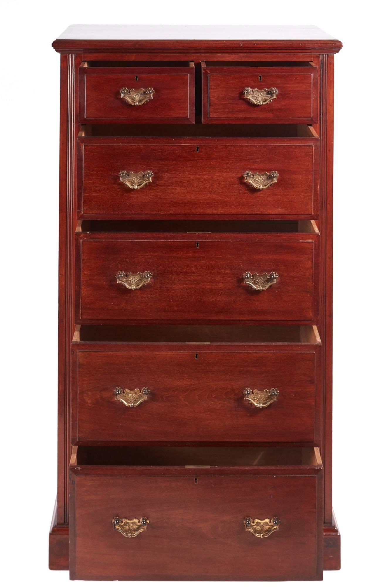Antique walnut chest of drawers, with a lovely walnut top, two short and four long drawers all with original brass handles and thumb moulded edge, reeded sides and lovely panelled ends, standing on a plinth base.