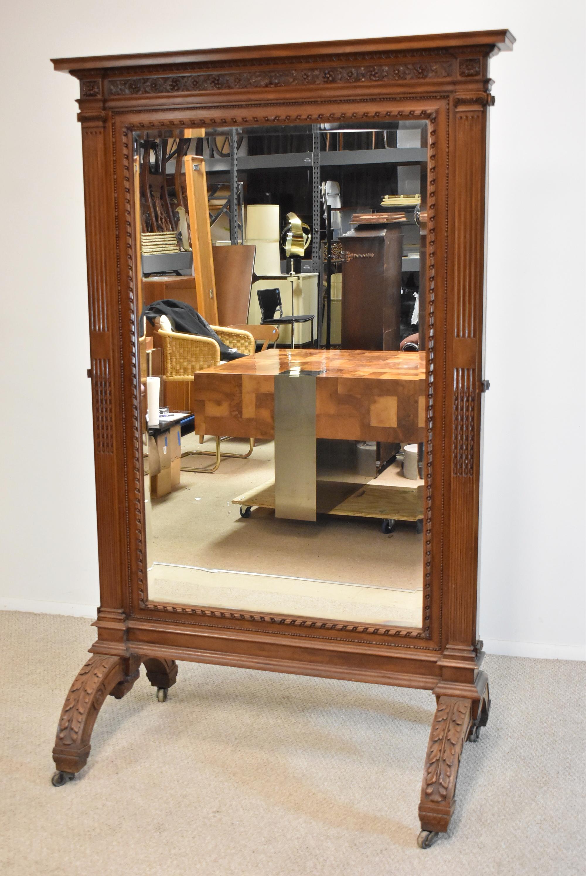 Antique walnut Cheval dressing full length triple mirror circa 1890's. Nicely carved frame. Three beveled mirrors. Large floor castors on the legs. Side hinged mirrors open to 91