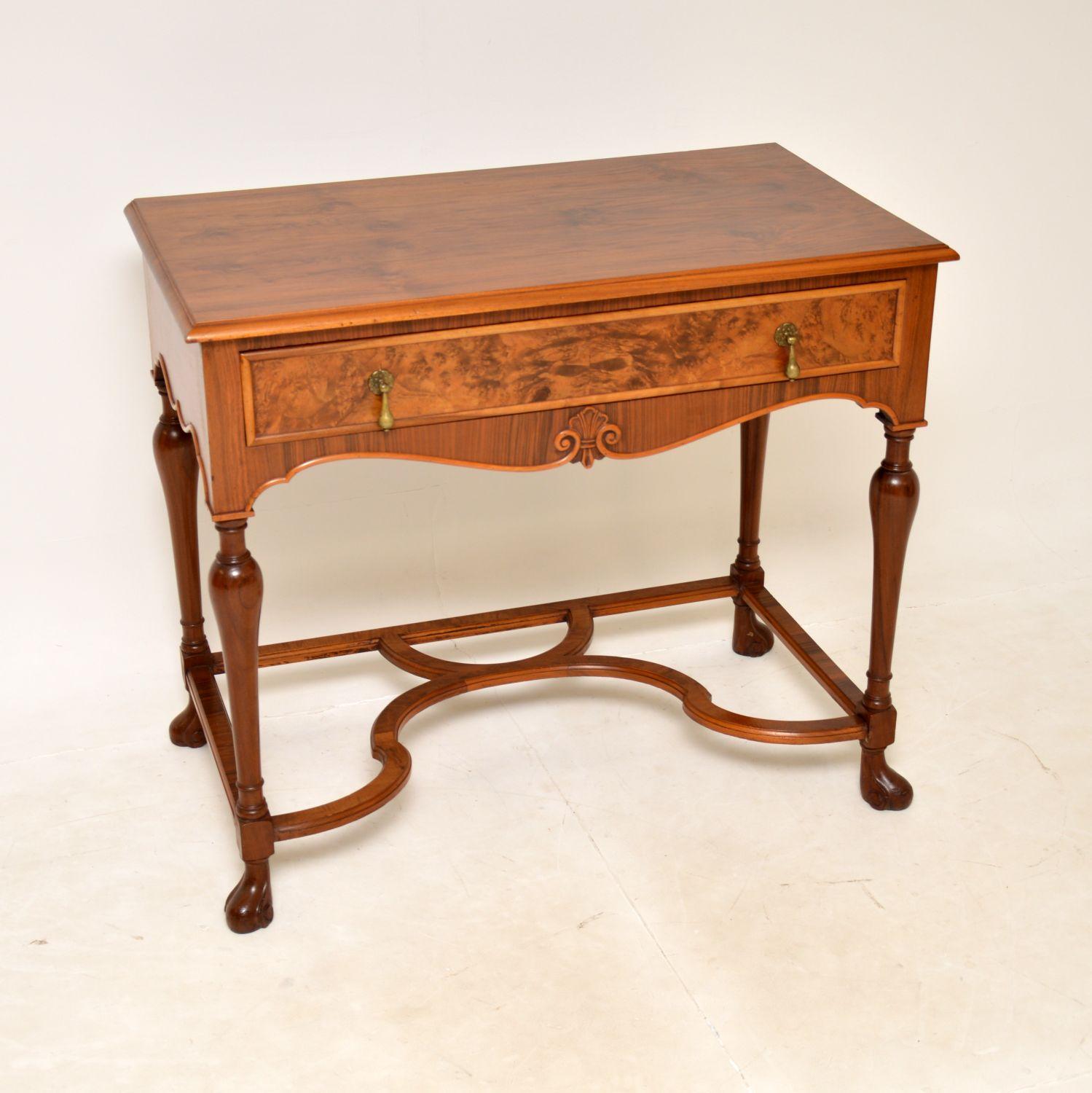 A beautiful and impressive antique console / side table in walnut. This was made in England, it dates from around the 1930’s period.

It is of superb quality, with a stunning burr walnut drawer front and lovely figured walnut top and sides. The