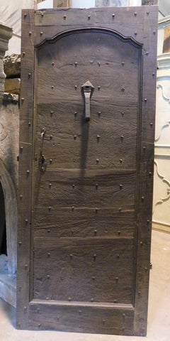 Antique walnut entrance door in rustic style, with nails, 18th century Italy