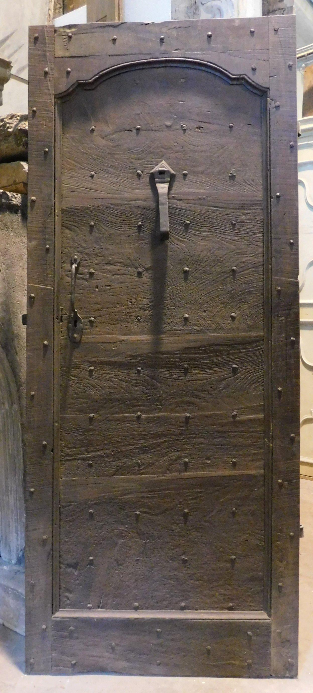 Italian Antique walnut entrance door in rustic style, with nails, 18th century Italy
