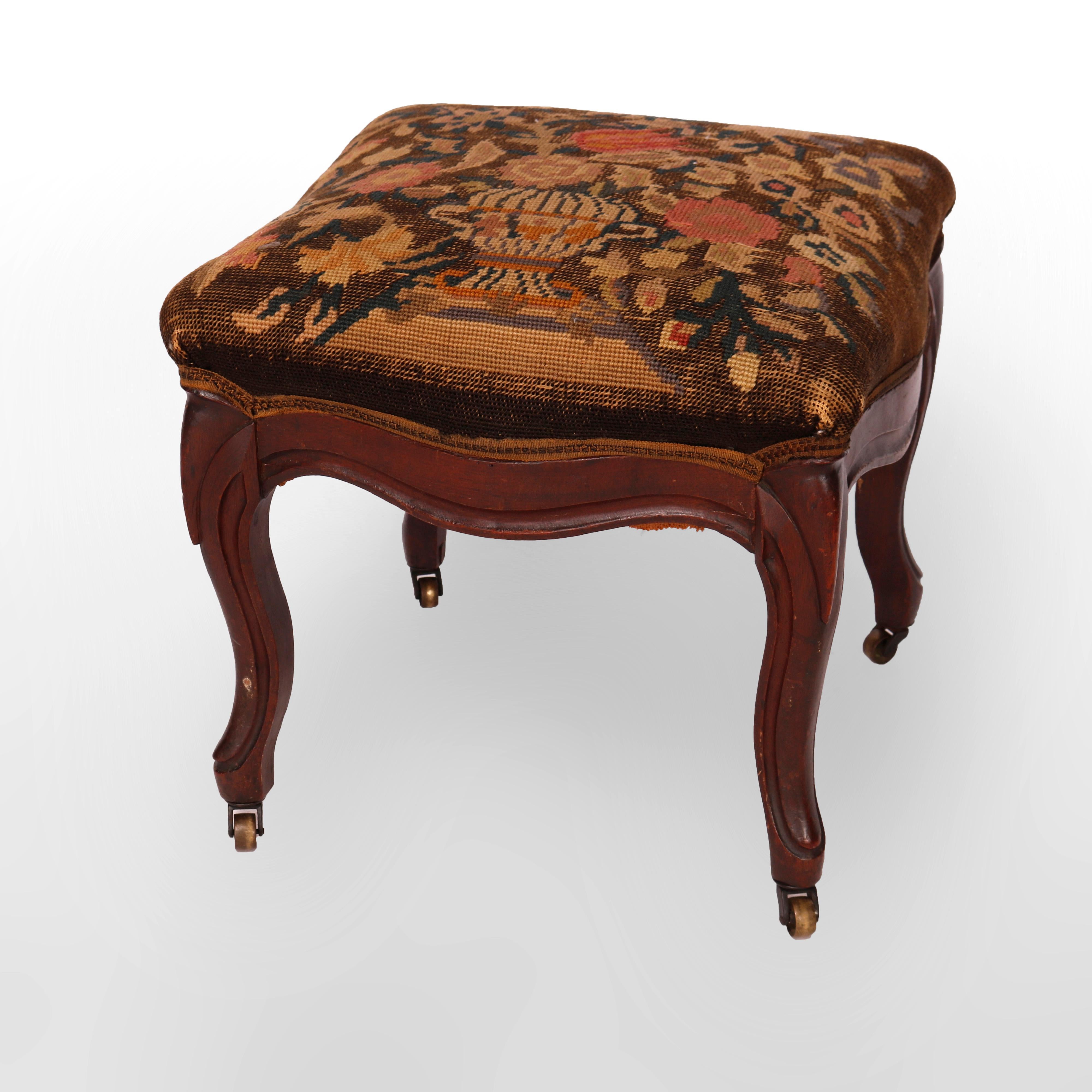An antique footstool offers needlepoint seat with floral urn design over finger carved walnut base having cabriole legs, c1890

Measures - 15'' H X 15.5'' W X 15.5'' D.

Catalogue Note: Ask about DISCOUNTED DELIVERY RATES available to most regions