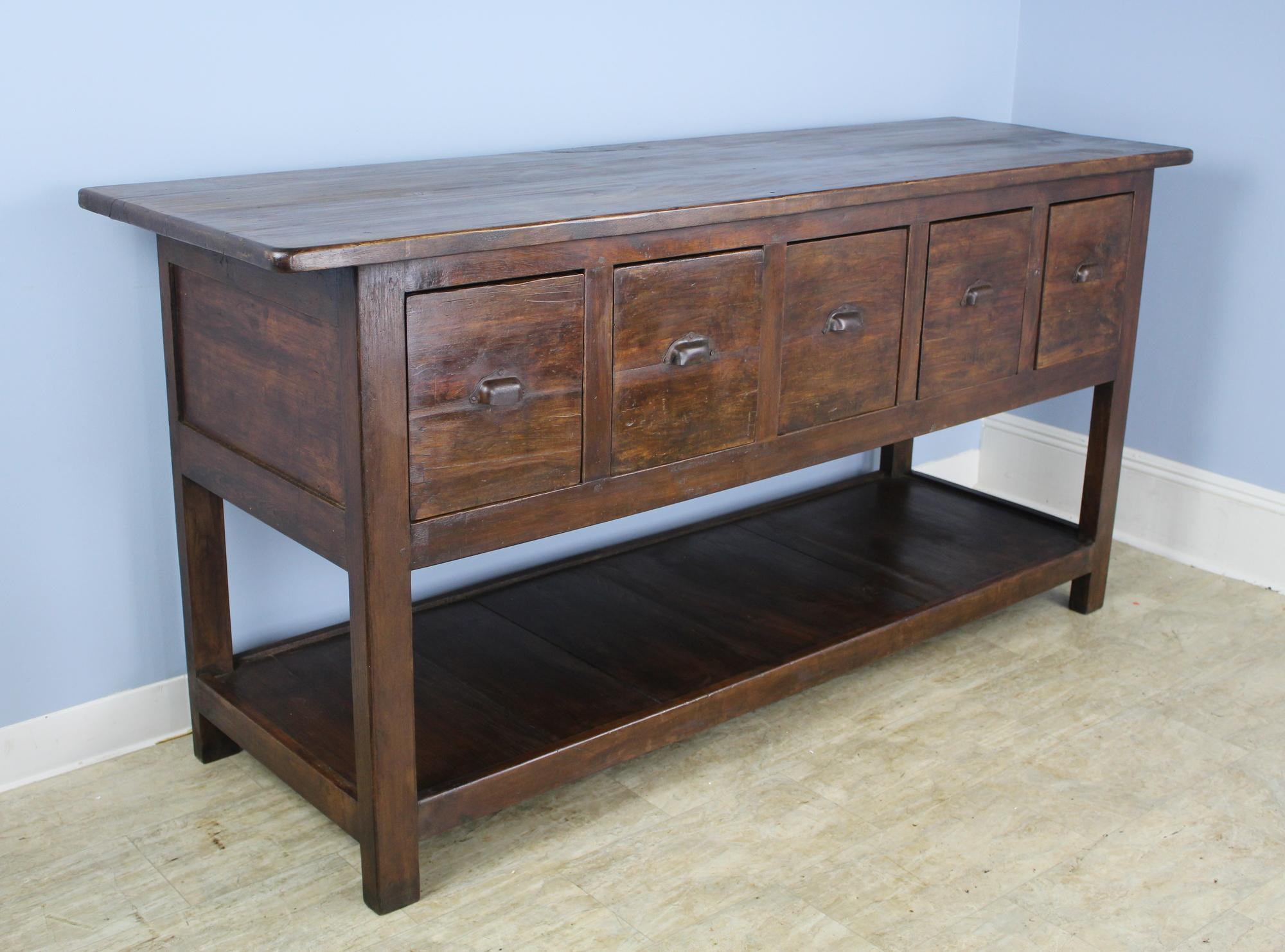 A handsome and dramatic five drawer piece that can be used as a server, sideboard or as a counter component in the kitchen. Perfect height for a work surface. The interiors of the five roomy drawers measure 9.25 inches wide x 18.75 inches deep x
