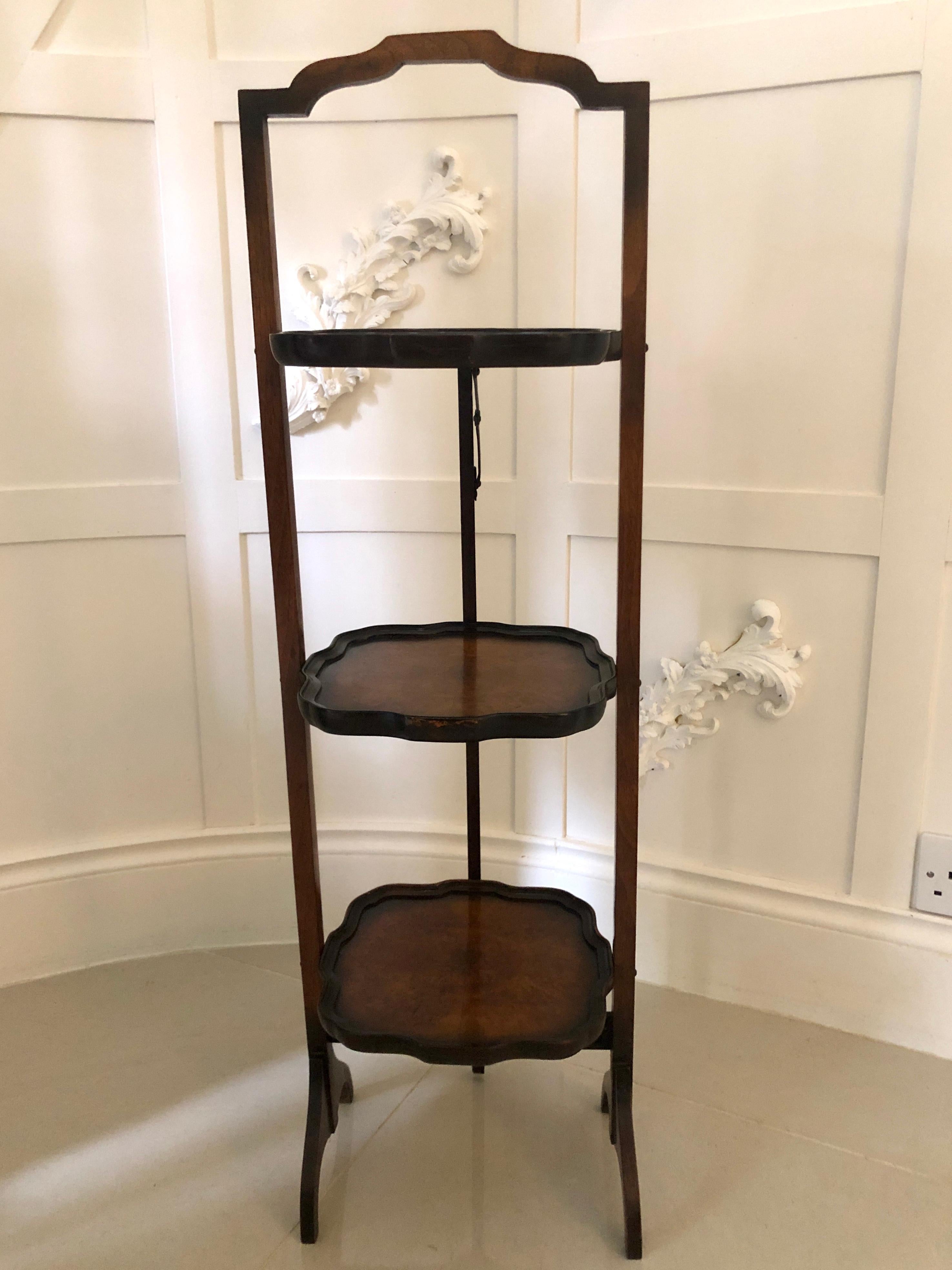 An attractive antique walnut 3-tier cake stand having a lovely shaped top and 3 shaped tiers. The tiers are crafted in walnut which boasts a beautiful shade. It folds for easy storage and stands on elegantly shaped walnut legs.

Measures: Cake