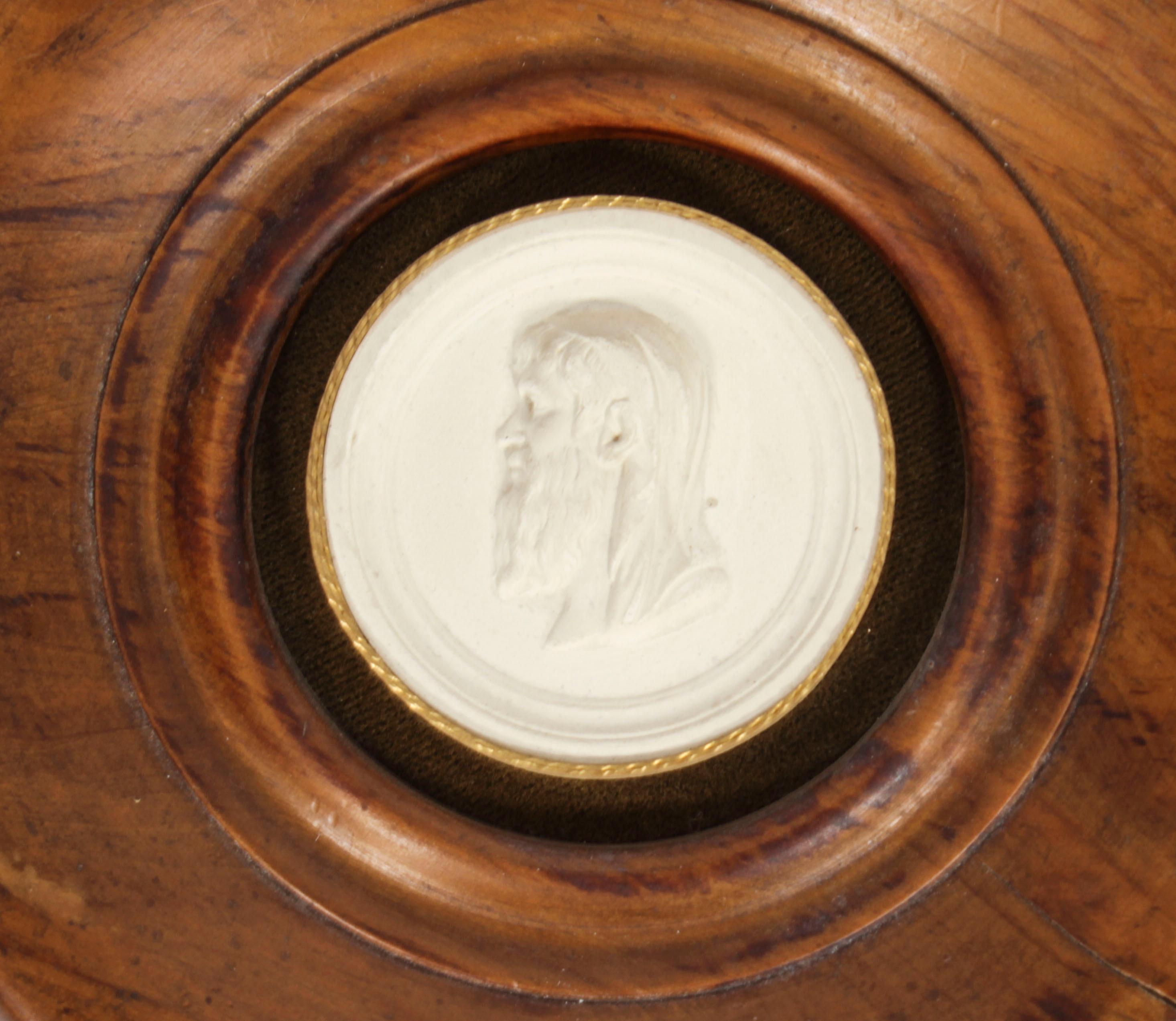 An  elegant framed plaster Grand Tour Giovanni Liberotti intaglio of Aristotle  dating from the early 19th Century.
 
The circular plaster intaglio comprises a portrait bust of the ancient philosopher Aristole
 
The intaglio is beautifully mounted