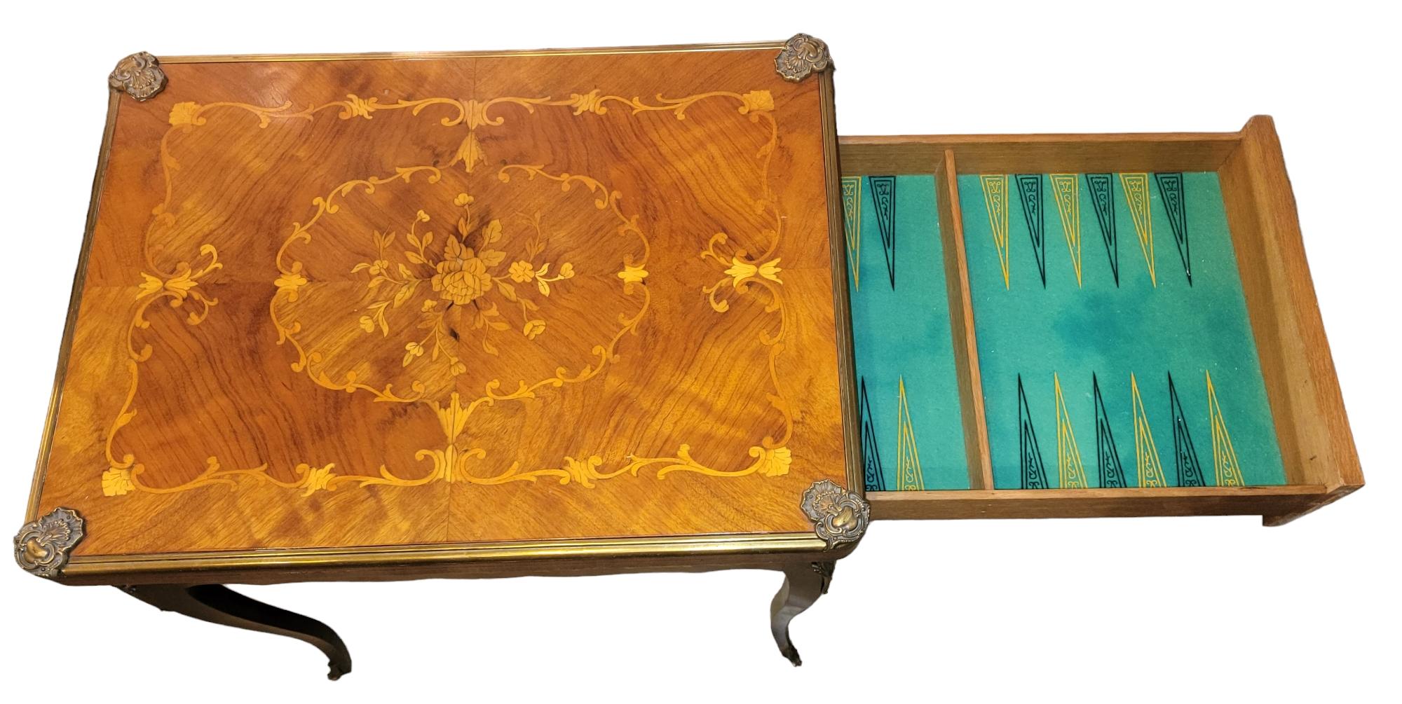 Antique Walnut French game table with ormolu mounts, slide-out felt-lined backgammon board, reverse top for card games. Drawer has slide our Backgammon board within. Table only There are no game chips.

 Circa 1920s 30h x 29L x 21w on floor.
