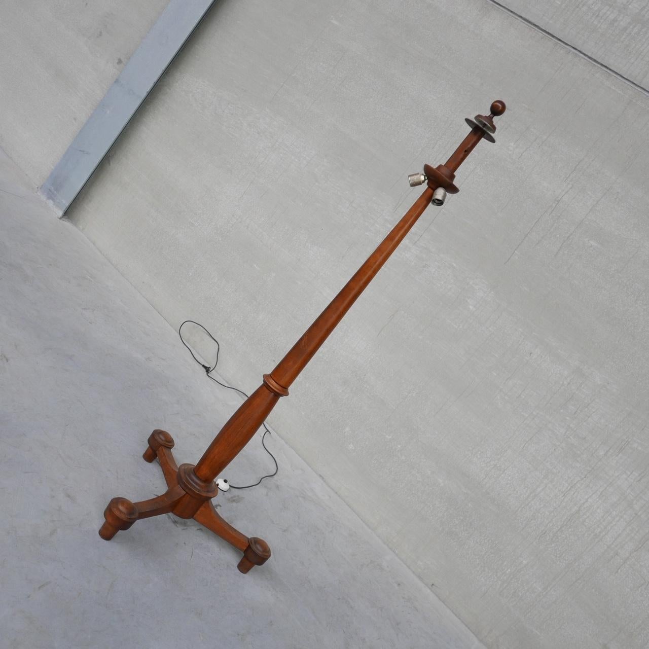 A tall antique floor lamp. 

France, c1930s. 

Simple elegant form raised over tripod legs. 

Solid wood, likely Walnut. 

Since re-wired. 

Not sold with a shade as they are easy to source to taste. 

Location: Belgium Gallery.