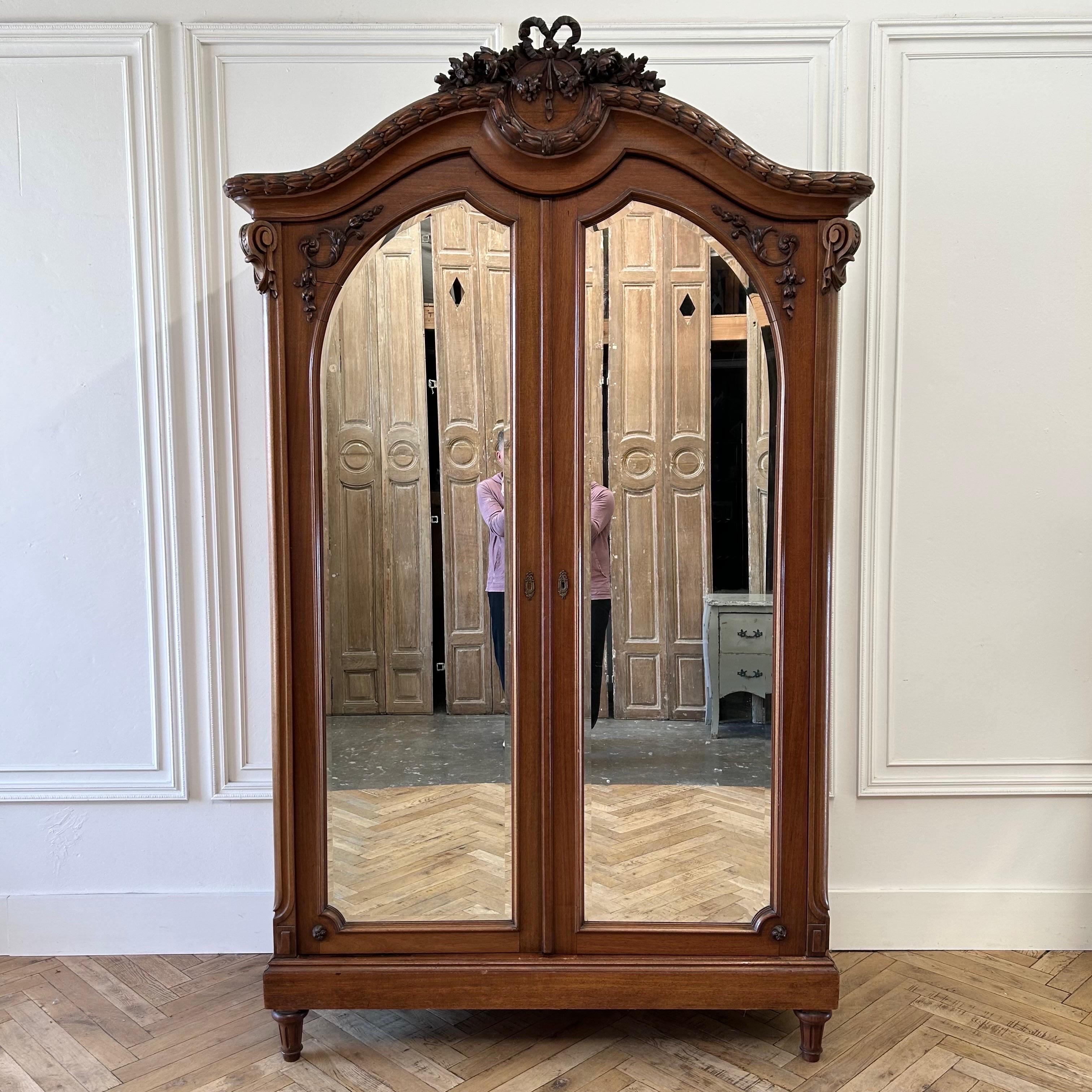 Armoire 60”w x 25”d x 100”h
Inside:53”w x 20”d
Rod:74”h from inside bottom 
Antique French Louis XVI Style Armoire with Ribbon And rose carvings.
Double door with mirrors, open and close with ease.
Inside has a hanging rod. Armoire does come