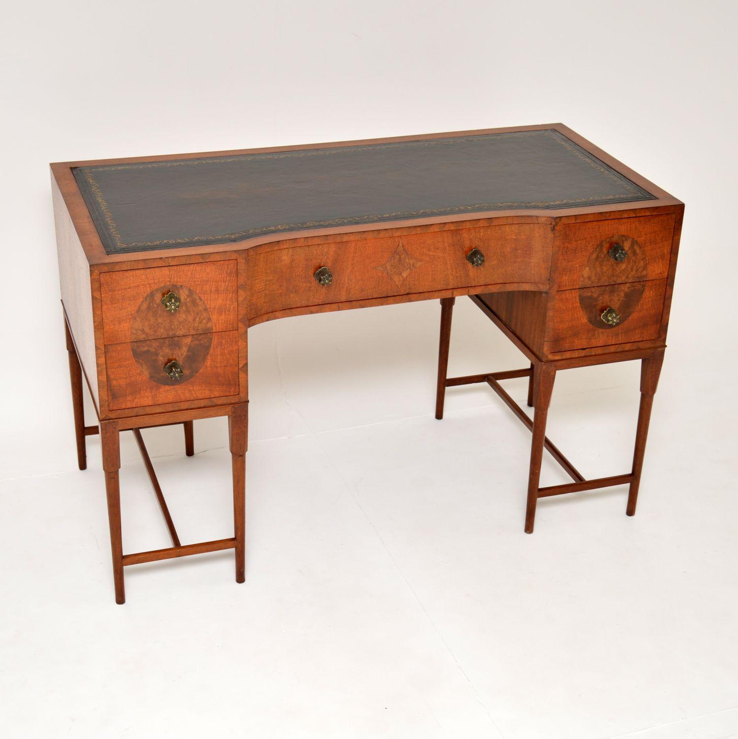 A superb antique leather top desk made from burr walnut. This was made in England, it dates from around the 1900-1920 period.

It is a fantastic size and is of wonderful quality. The carcass is wood, with the front edges inlaid in a beautiful
