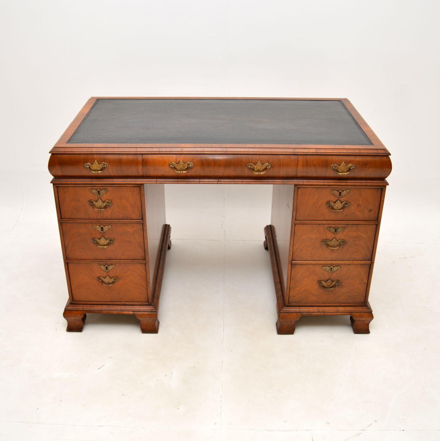 A superb antique walnut leather top pedestal desk. This was made in England, it dates from around the 1890-1910 period.

It is of extremely fine quality, with a gorgeous cushion top design. The walnut has a beautiful patina and colour tone, this has