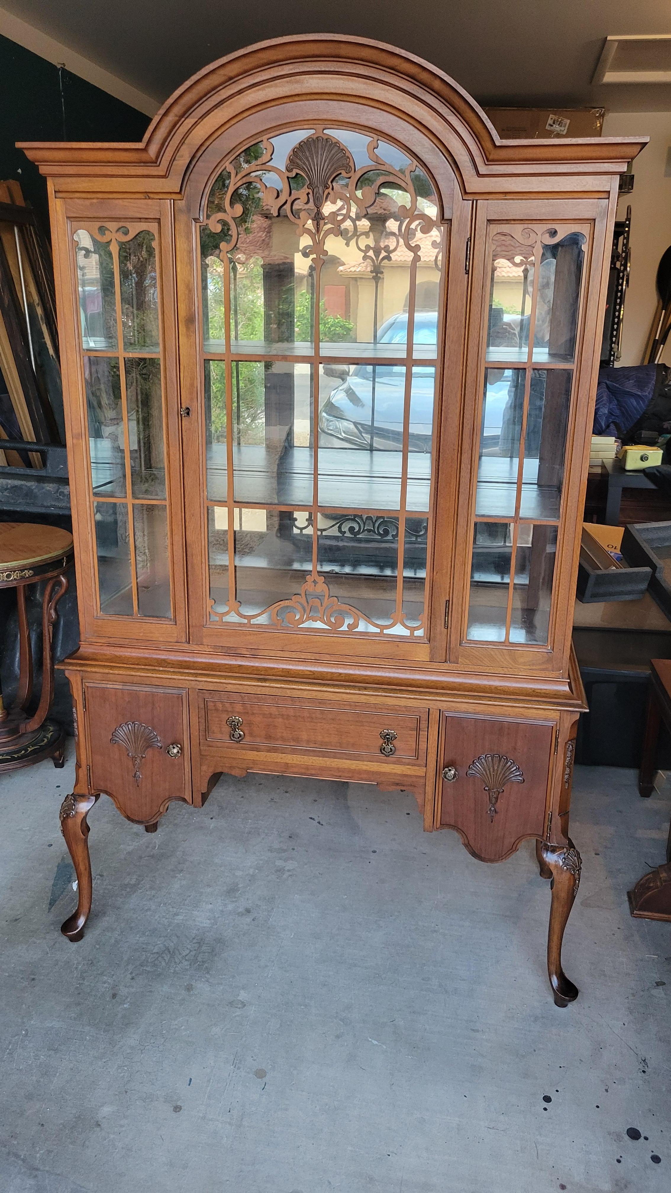 Antique walnut china hutch with two shelves and mirror in the back. 
The bottom part has 2 cabinets and a silver-ware drawer.
We estimate that the hutch was made in the late 1800s. This piece is sturdy and quite heavy.