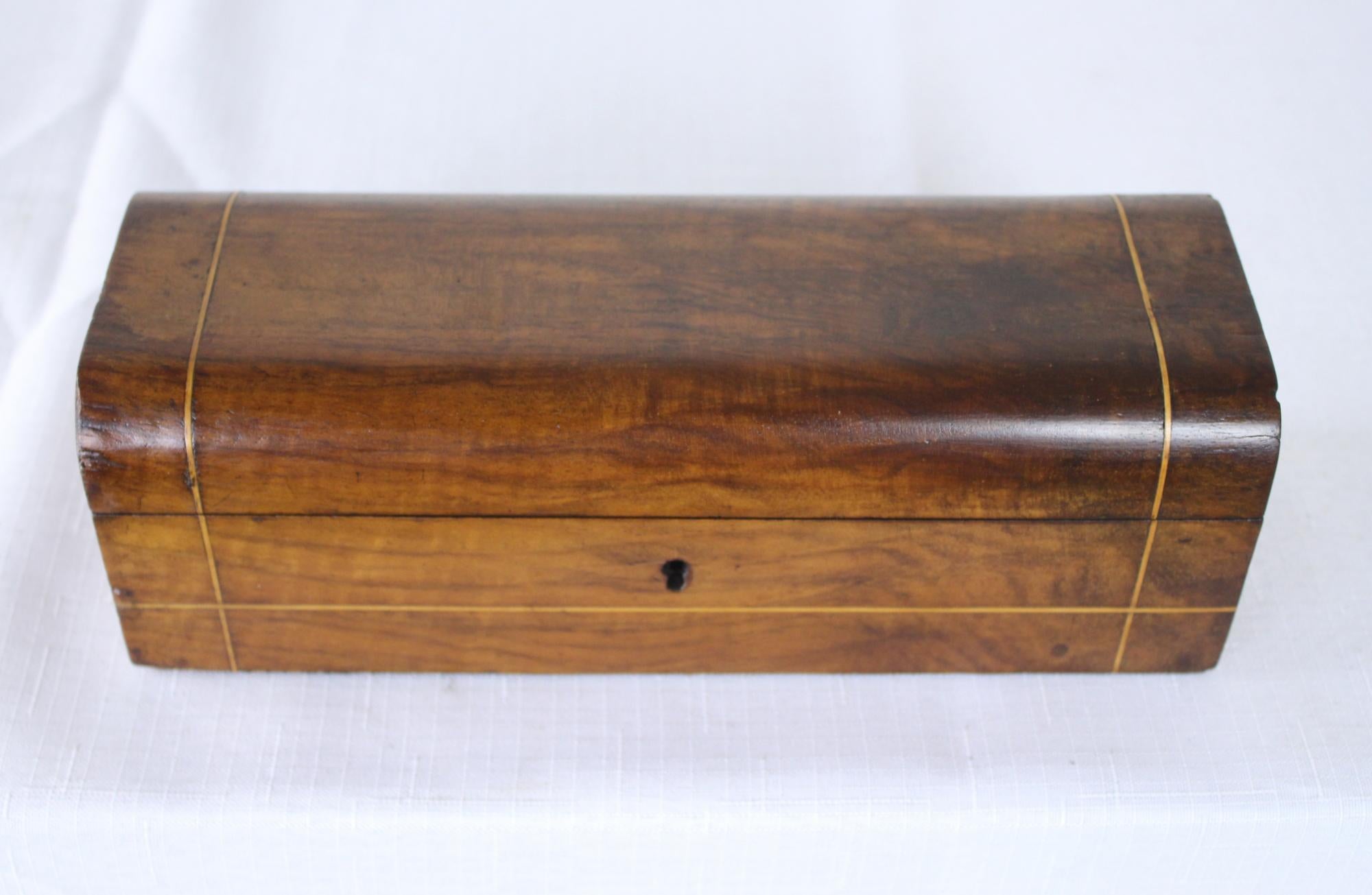 A sleek antique English walnut pencil box with good grain and a lovely soft patina.