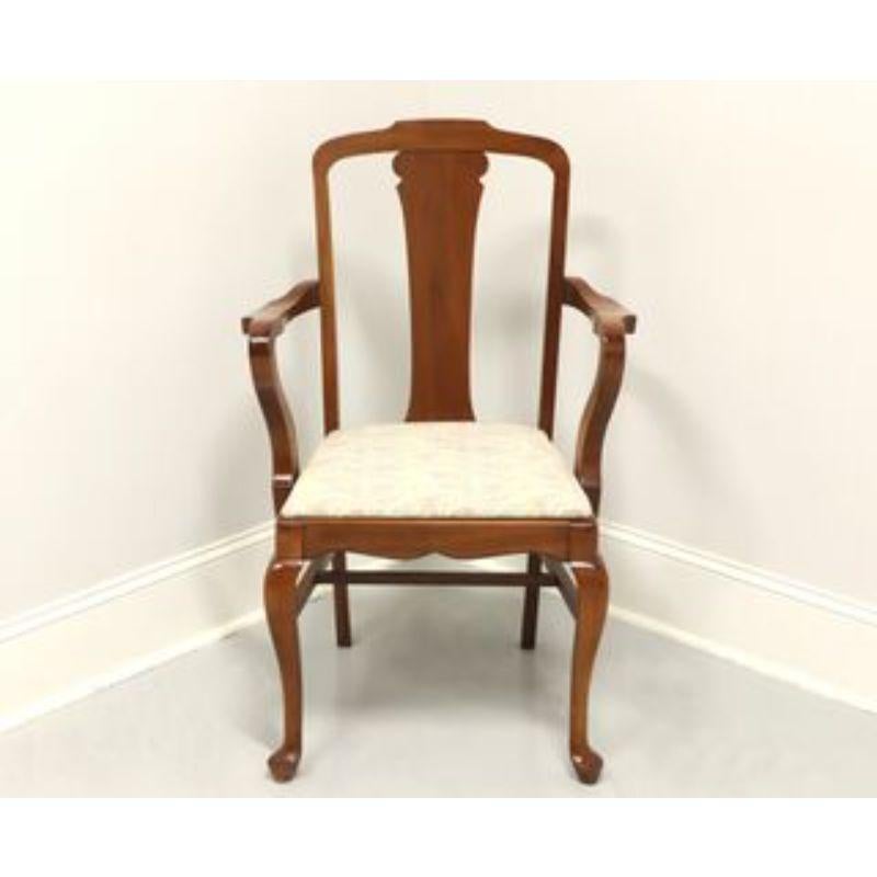 An antique Queen Anne style armchair, unbranded. Walnut with curved arms, neutral color fabric upholstered seat, cabriole legs and pad feet. Made in the USA, in the 19th century.

Measures: Overall: 25.5 W 24.5 D 38.5 H, Seat: 18.5 W 16.75 D 19 H,