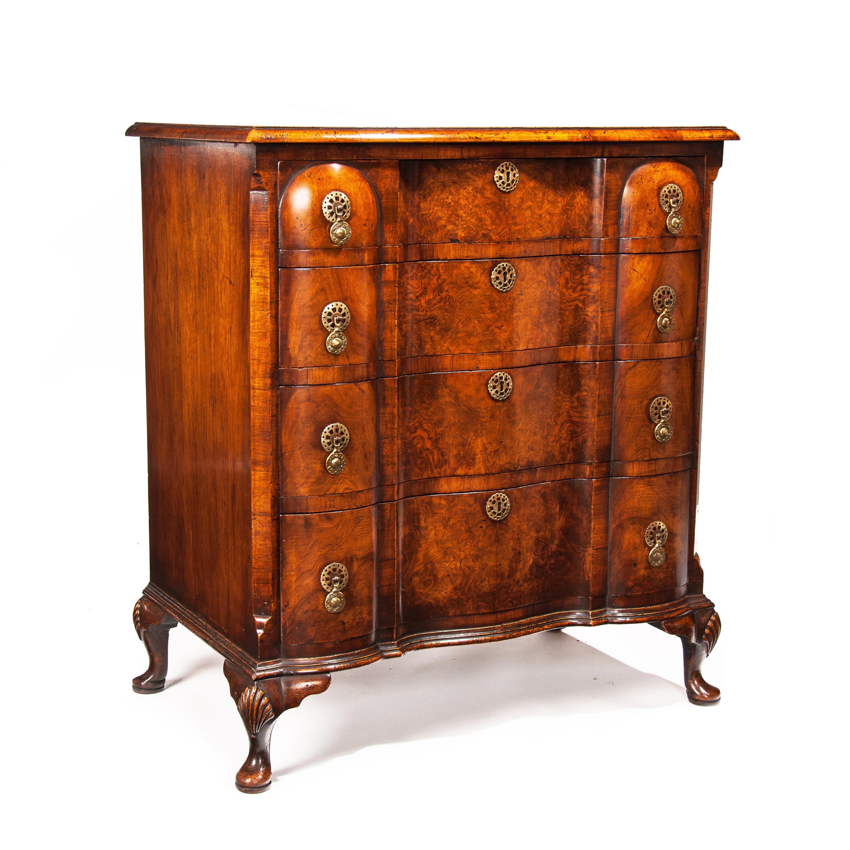 A superb quality antique shaped front walnut chest of drawers standing on cabriole feet, Queen Anne style.

English, circa 1900.


The construction of this chest of drawers has been closely matched to an 18th Century example with fine attention