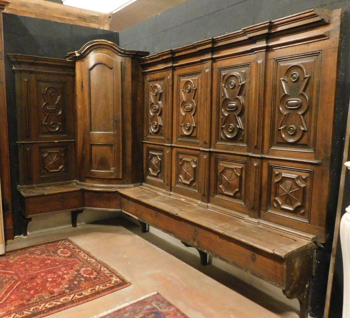 Ancient sacristy choir, with many benches, seats with corner cupboards and opening seats, n. 2 L-shaped bodies, hand-carved with ancient tile, in precious brown walnut wood with a patina due to the centuries, hand-made in the 16th century for a