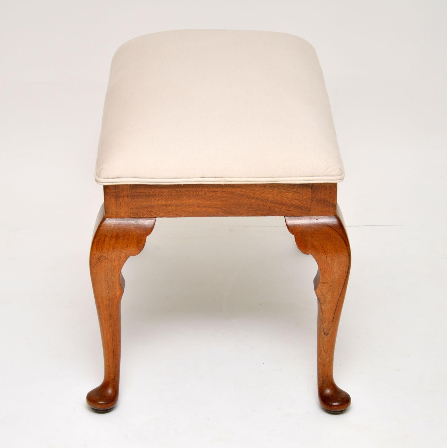 Antique solid walnut Queen Anne style stool in excellent condition, dating from circa 1910s-1920s period. It’s just been French polished and re-upholstered in our regular cream cotton linen fabric.

Measures: Width 28 inches, 70 cm
Depth 17