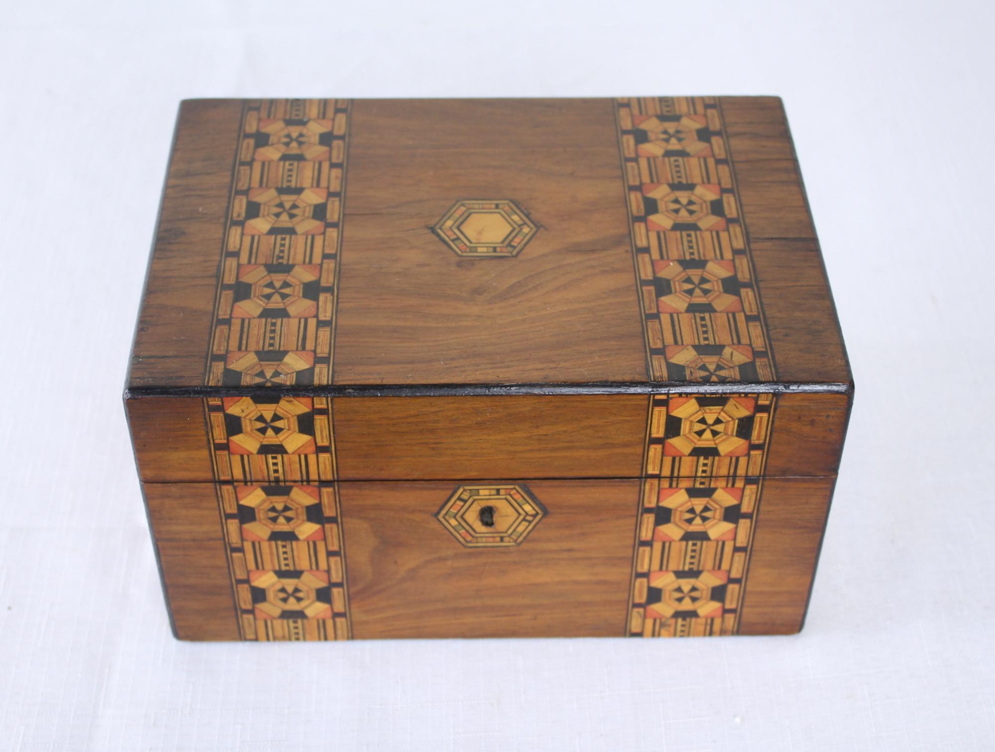 A decorative walnut Tumbridgeware jewelry box. Tumbridgeware being characterized as a form of decoratively inlaid woodwork, typically in the form of boxes, that is characteristic of Tumbridge and the spa town of Royal Tumbridge Wells in Kent in the