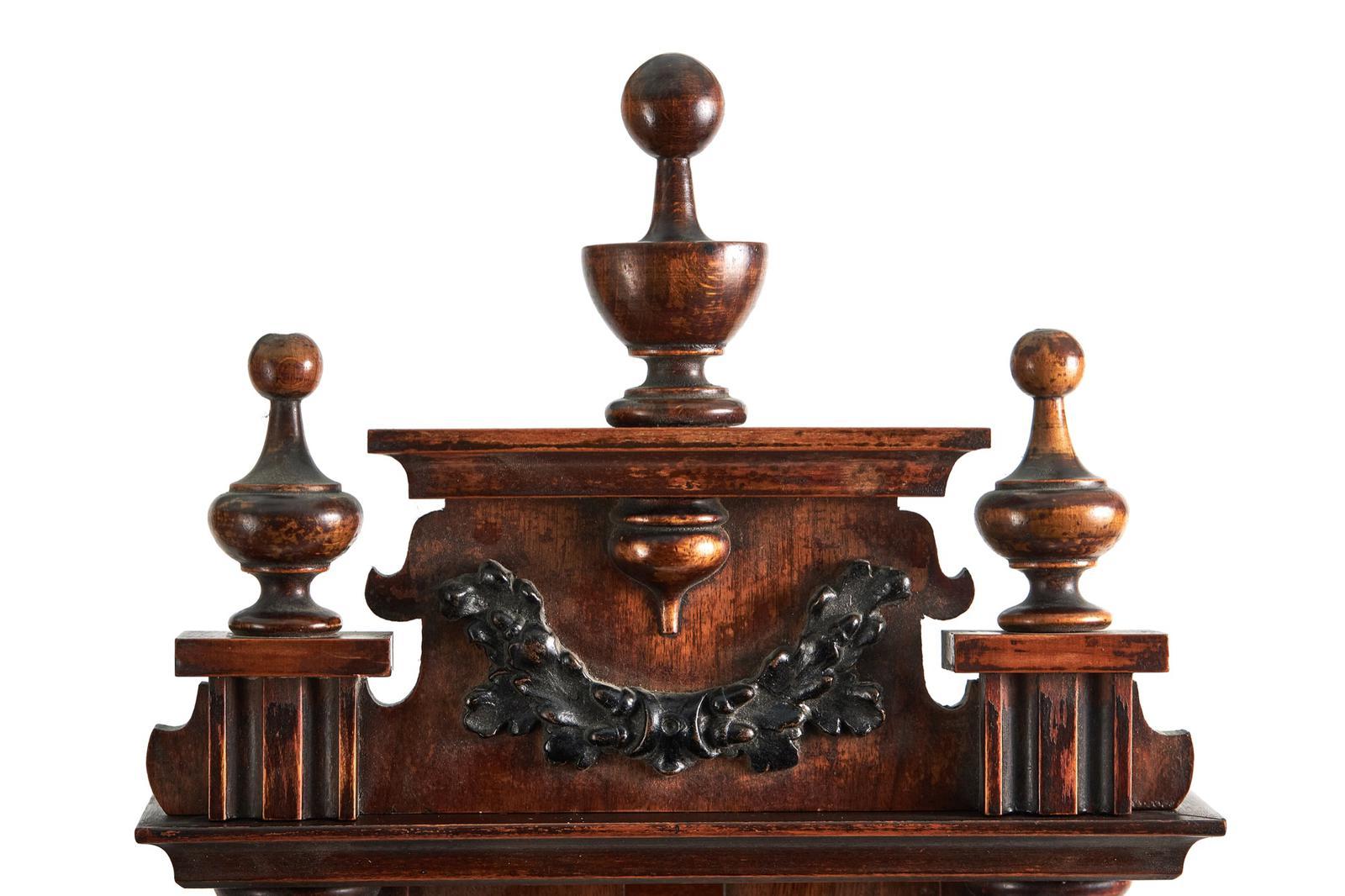 Antique Walnut Wall Clock, having a quality carved walnut case with original turned finials, reeded columns and solid walnut carvings and glazed and walnut door opening to reveal a circular enamel and brass clock face with roman numerals. Twin train