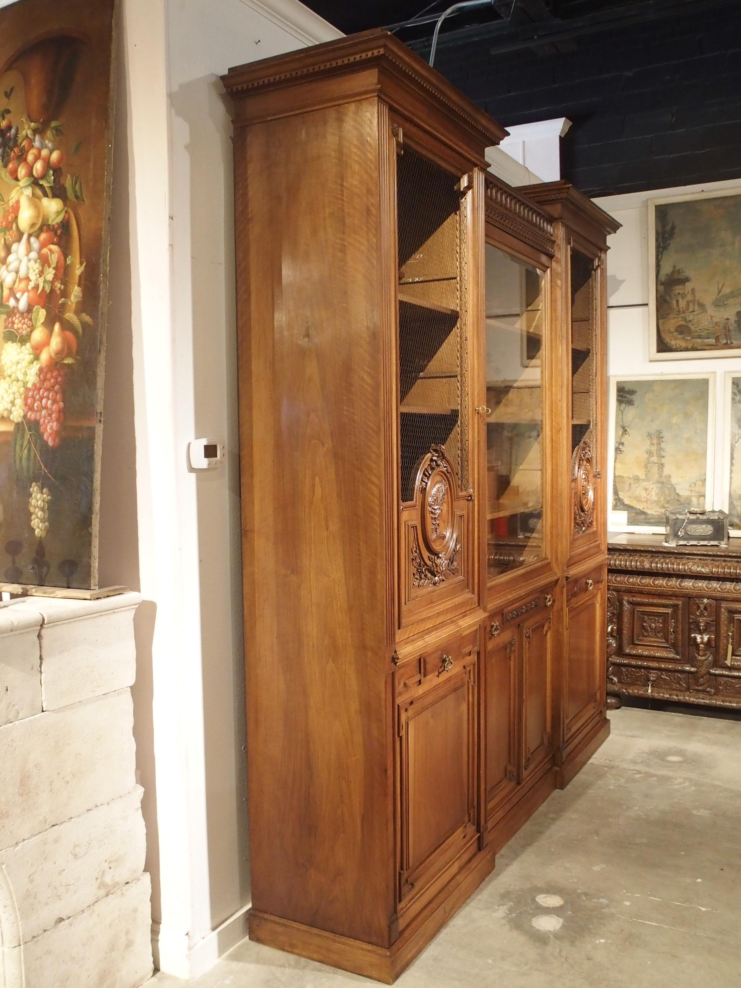 This large and elegant French bibliotheque is made of walnut wood and dates to the latter half of the 1800s. It recently came from a beautiful home in the Dordogne region of Southwestern France, where it was well kept for many years. The overall