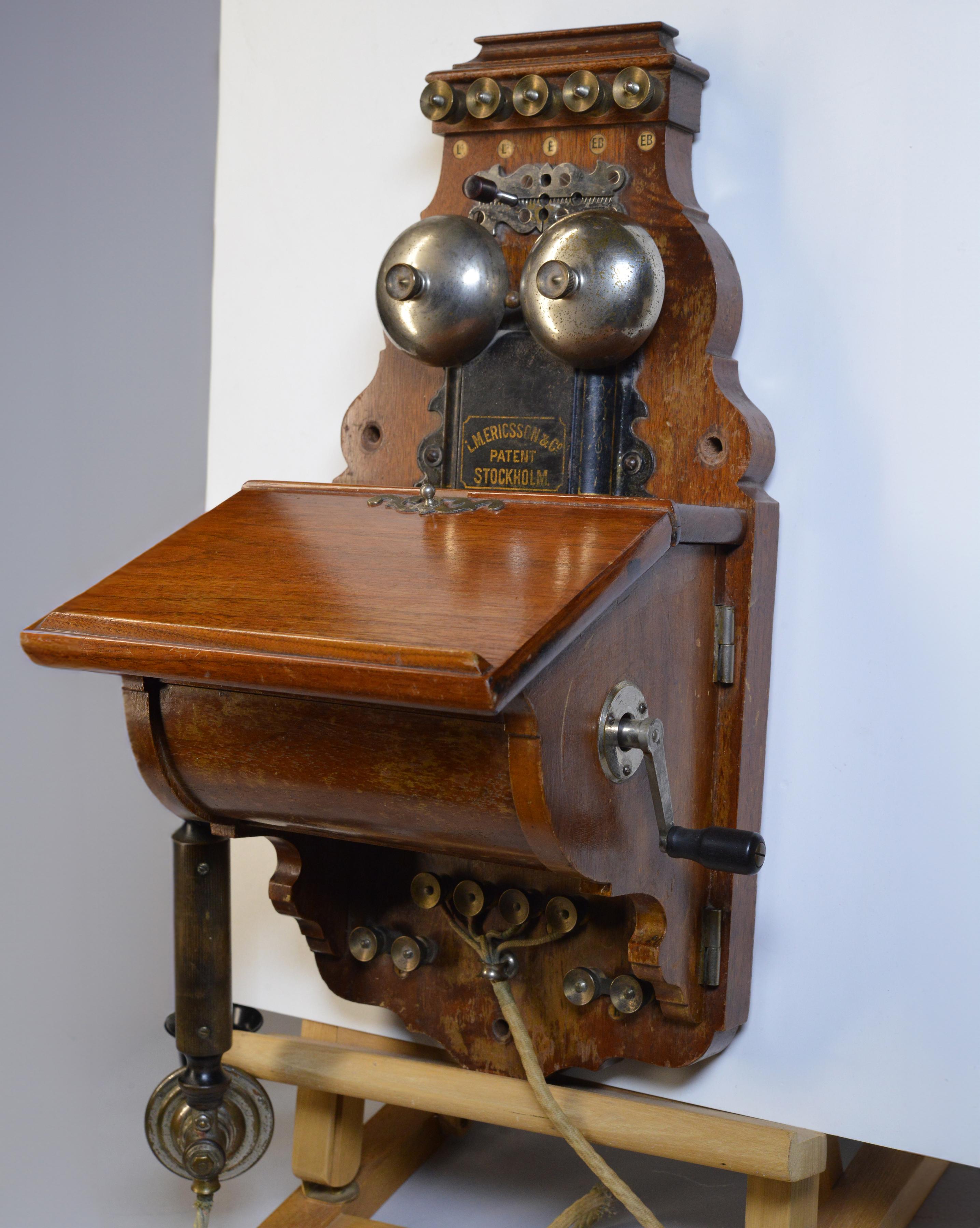 Household phone model AB130, advanced version of AB316, made ca 1912 by L.M.Ericsson & Co, Stockholm. 
Size app.: 46 cm (18”) high, 25 cm (9.8”) wide and 23 cm (9.1) deep. Very good, age n usage wear, losses to finish of case. Please study high-res