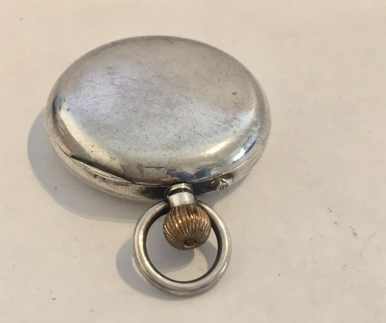 This beautiful 50mm diameter keyless hand winding pocket watch is in good working condition and it is ticking well. Visible signs of ageing and wear with small and light surface marks on the watch case as shown. Please study the images carefully as